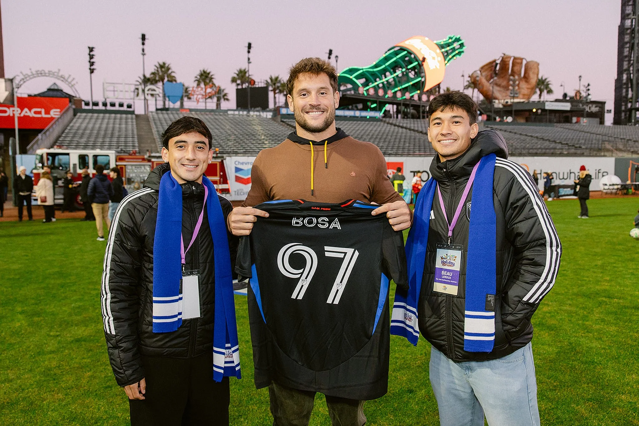 Nick Bosa of the San Francisco 49ers at a Holiday Heroes charity event at Oracle Park. Documentary-style event photography in San Francisco by Michaela Joy Photography.