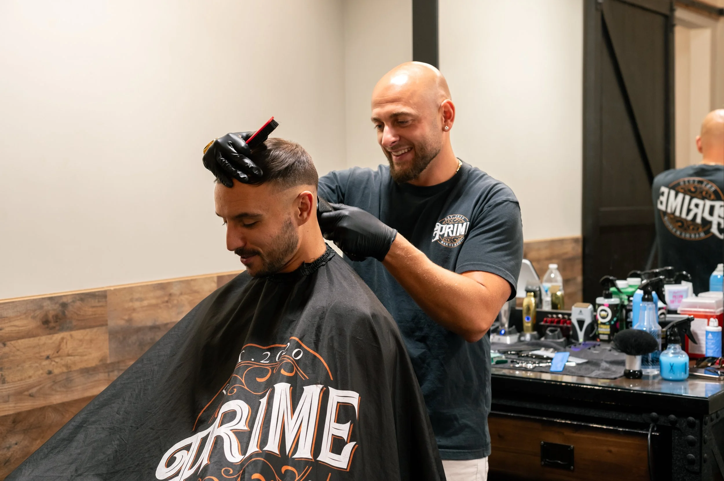Barber cutting a man's hair in a salon.