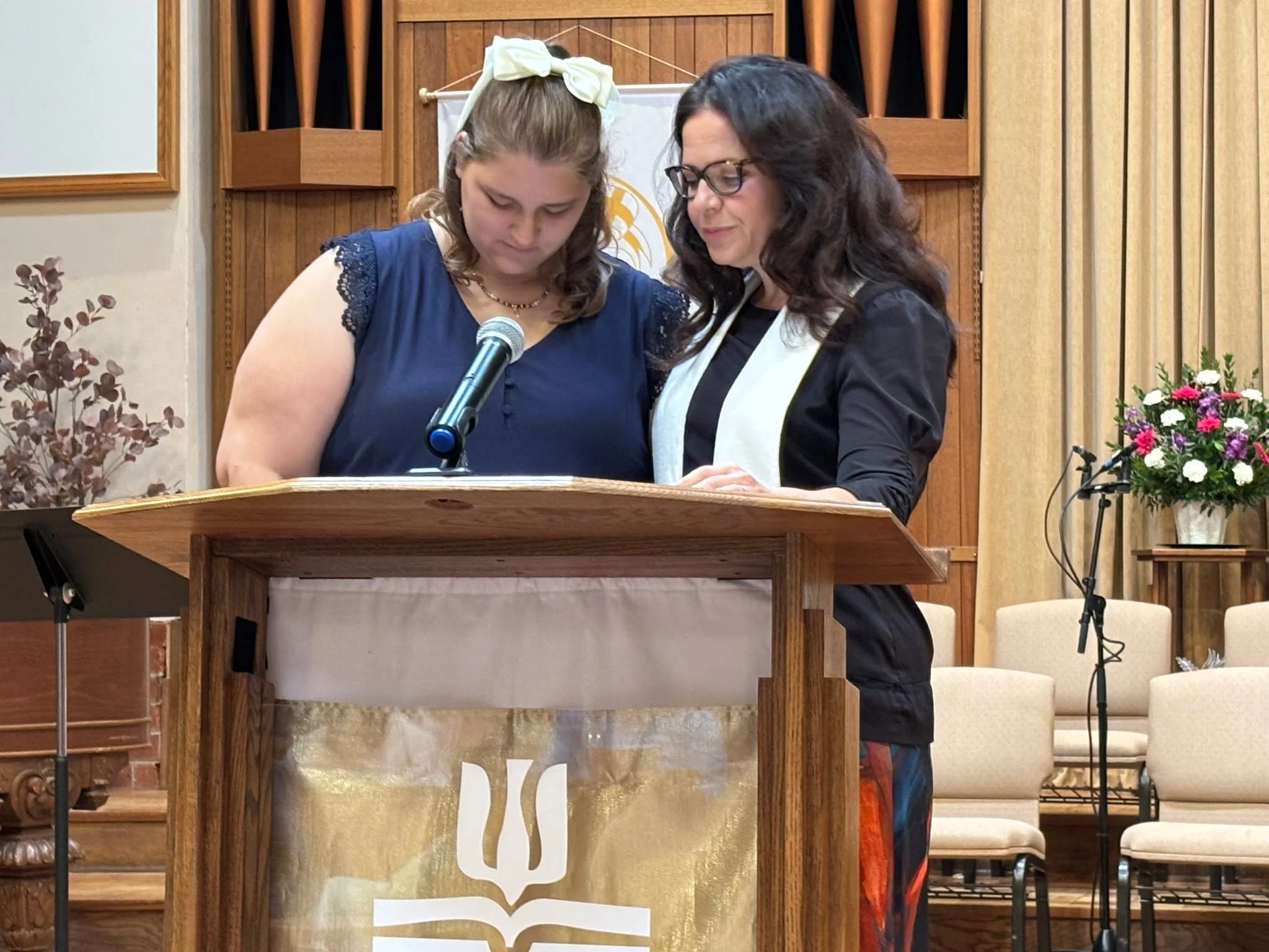 In Case You Missed It: Makayla Manosh is serving up at Forest Home Christian Camp this summer! The picture above captures Pastor Kim offering her a prayer commissioning at one of our recent worship services. Our prayers are with you Makayla! Photo Cr