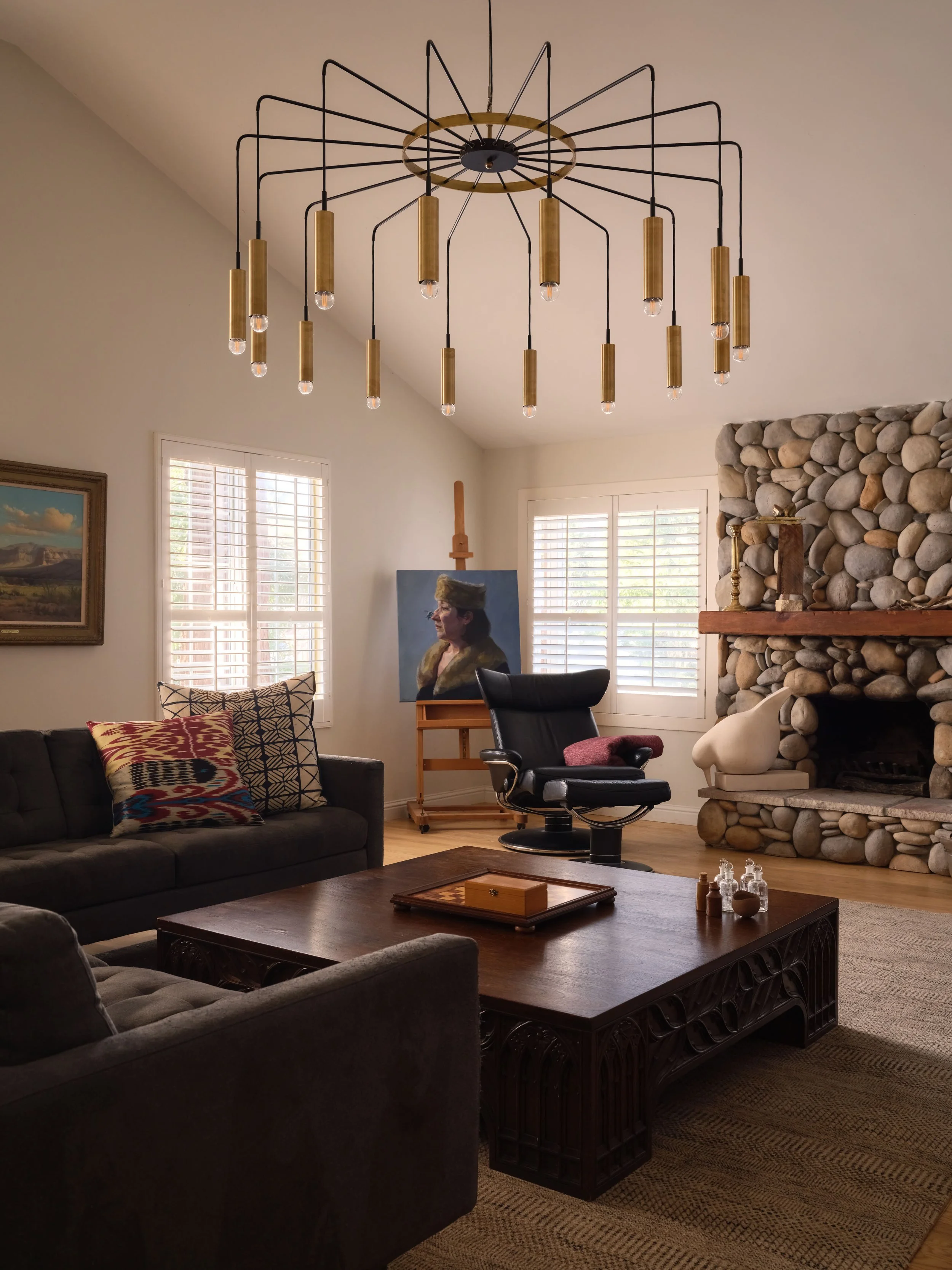 Living room with river-rock stone fireplace, wood mantel, and black leather recliners, Alamo Farmhouse entire-home remodel (Jackson Way, Alamo) by Spearman Spaces