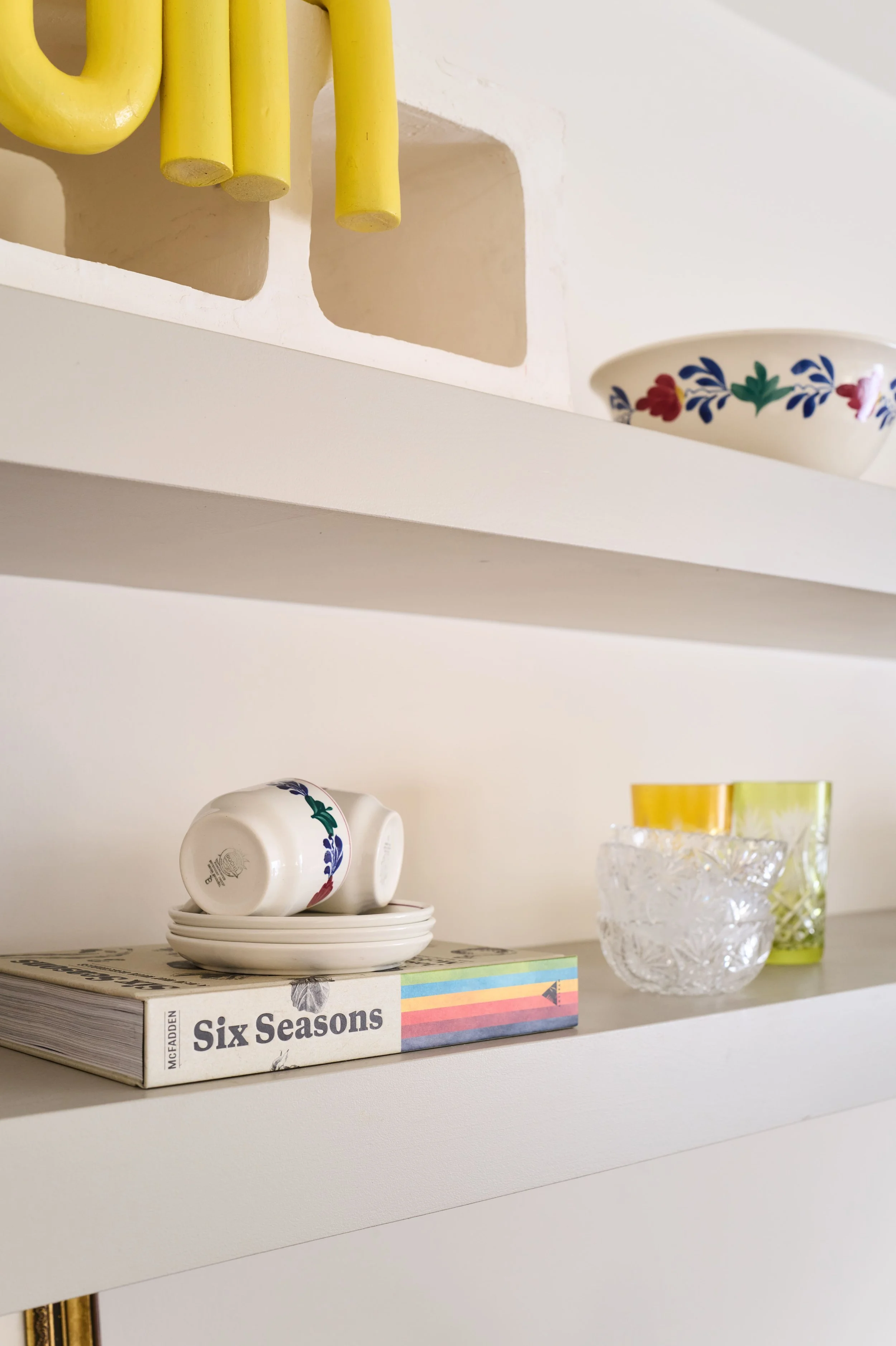 Built-in shelving with stacked books including "Six Seasons" and a crystal decanter, Alamo Farmhouse (Jackson Way) architectural remodel by Spearman Spaces