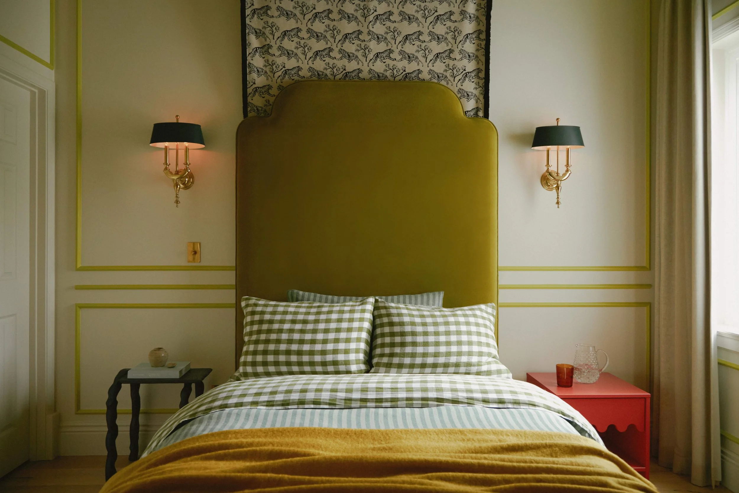 Boy's bedroom with olive green upholstered headboard, gingham bedding, and red vintage nightstand, full-service San Francisco Modern Victorian gut renovation by Spearman Spaces