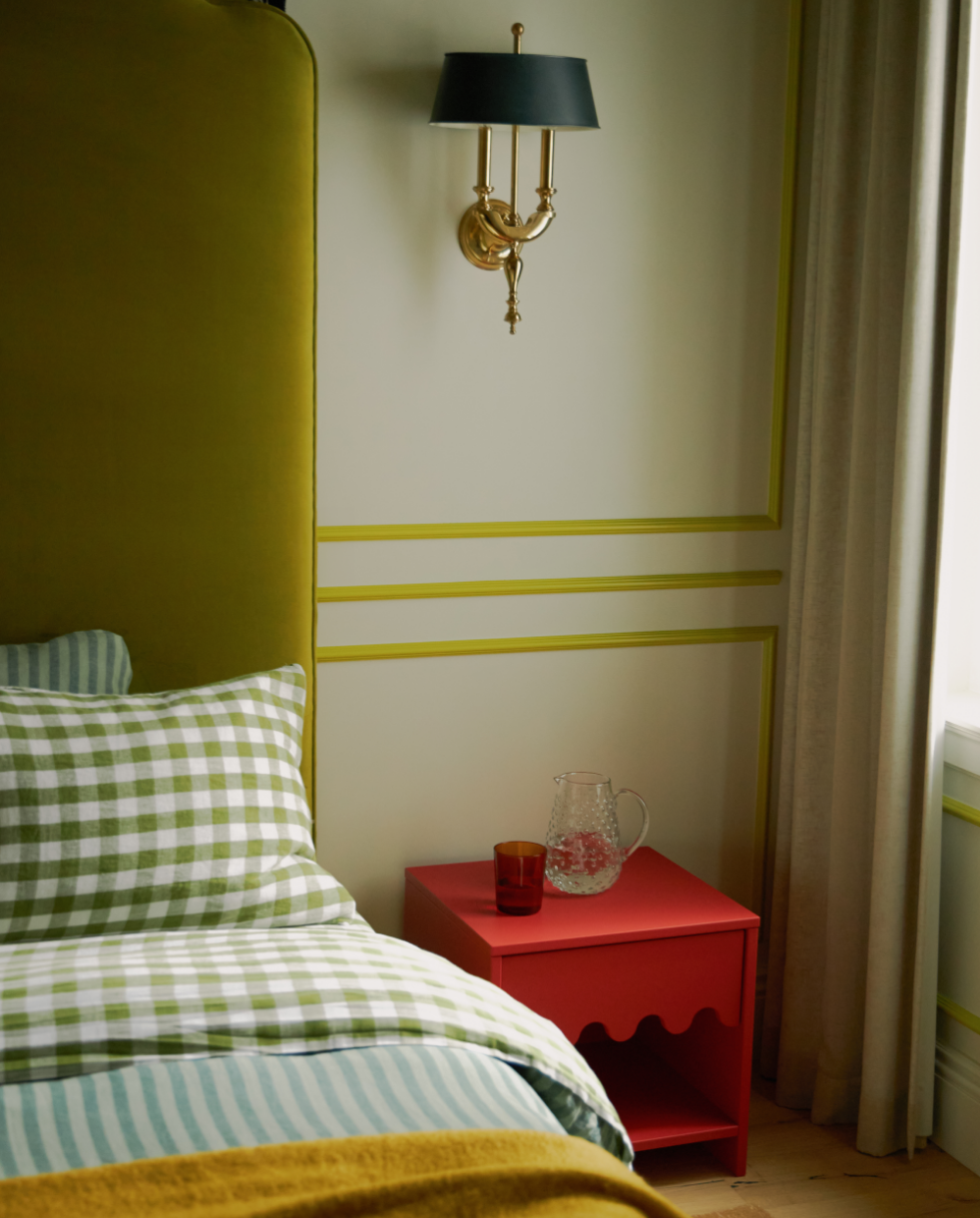 Boy's bedroom with olive green upholstered headboard, gingham bedding, and red vintage nightstand, full-service San Francisco Modern Victorian gut renovation by Spearman Spaces