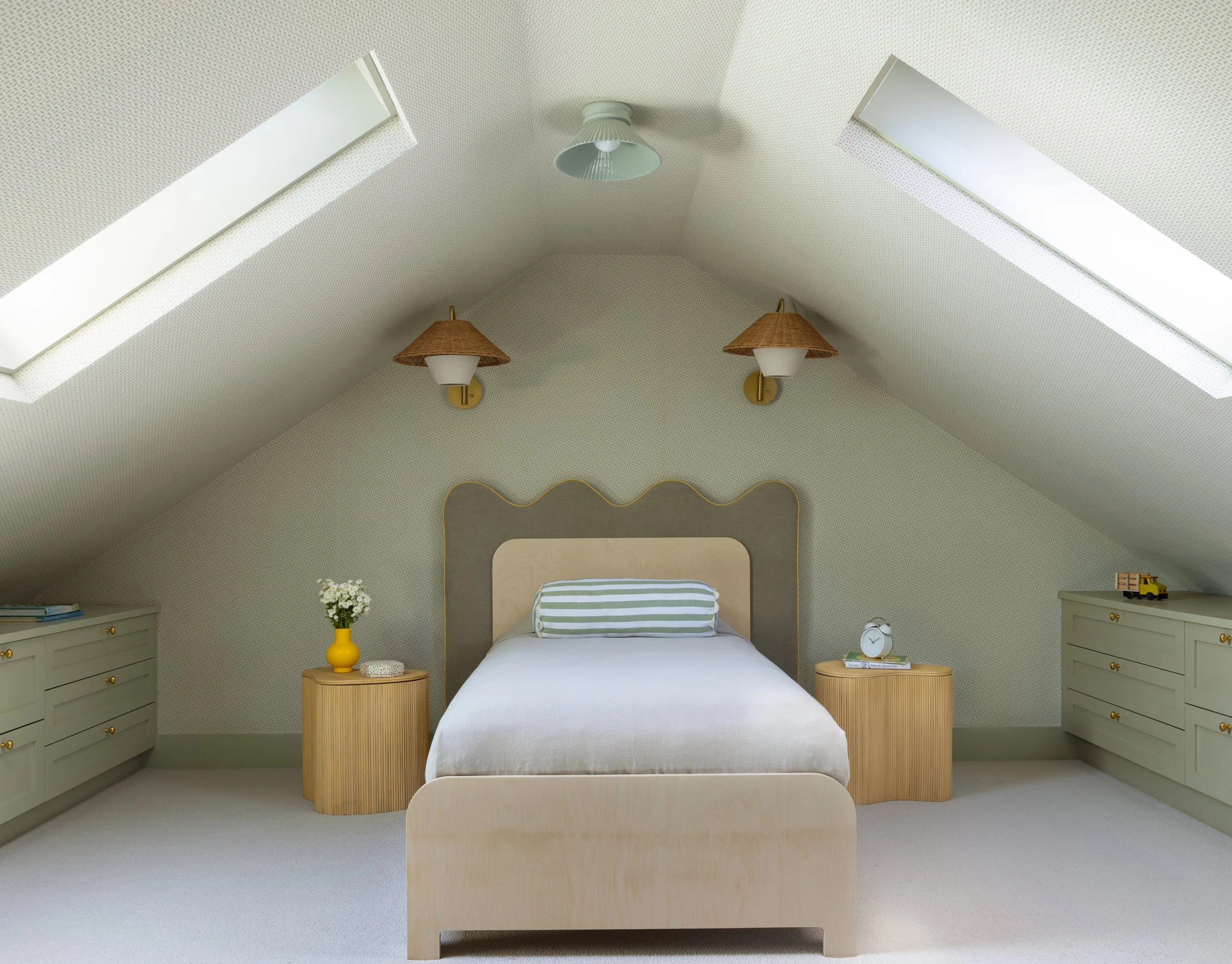 Children's attic bedroom renovation with sloped ceiling, sage green wallpaper, scalloped twin bed, and rattan wall sconces, Transitional Italianate (De Haro Street, Potrero Hill) remodel by Spearman Spaces