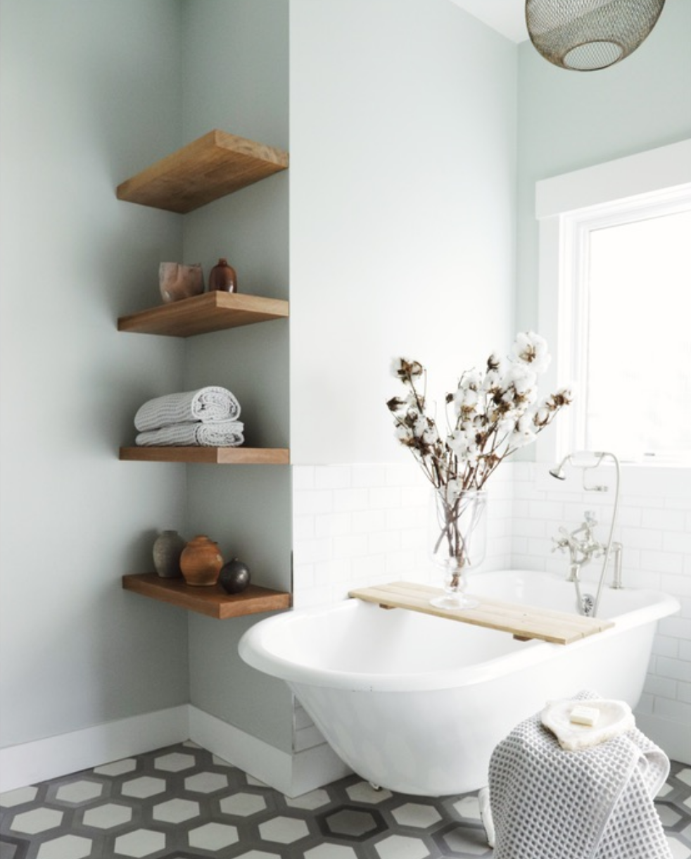 Complete bathroom remodel with a white clawfoot tub, black and white hexagonal floor tile, Oakland Bungalow (61st Street) renovated by Spearman Spaces, a full-service San Francisco interior design studio
