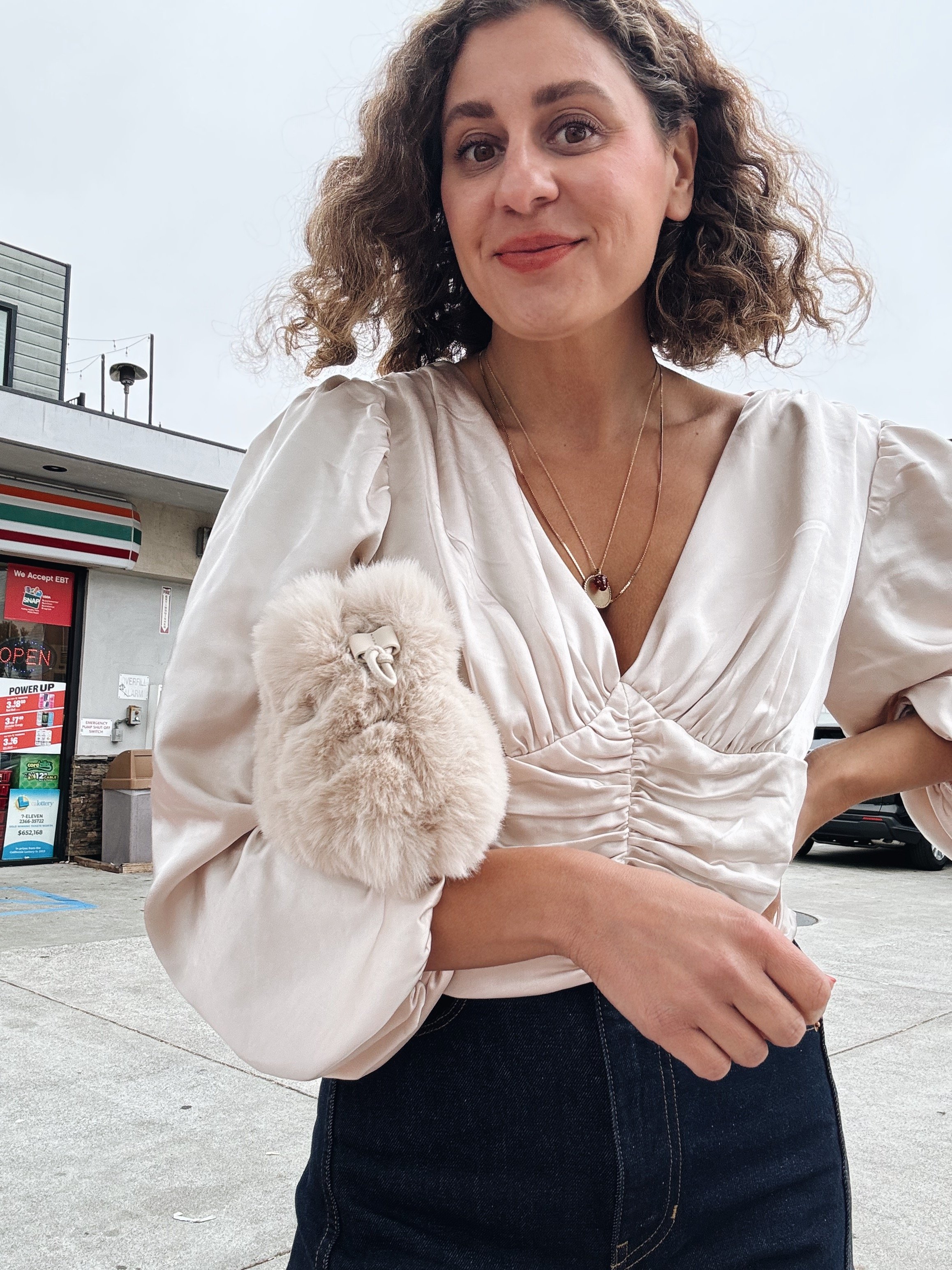 Jihan Spearman in a cream ruffled blouse on a city street, Spearman Spaces Instagram