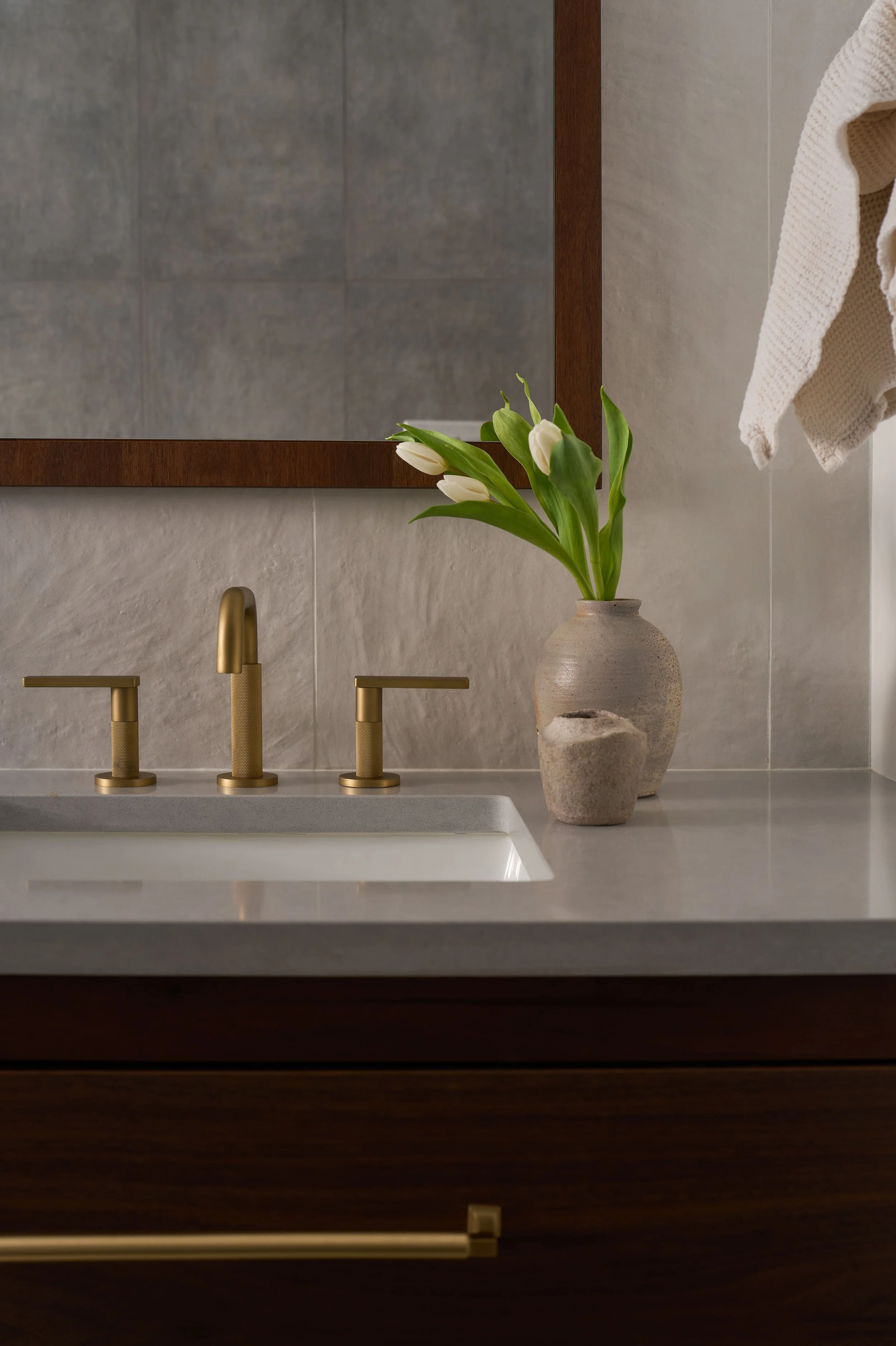 Bathroom vanity with brass widespread faucet, white tulips, and dark wood cabinetry, Alamo Farmhouse historic remodel and interior upgrade (Jackson Way, Alamo) by Spearman Spaces