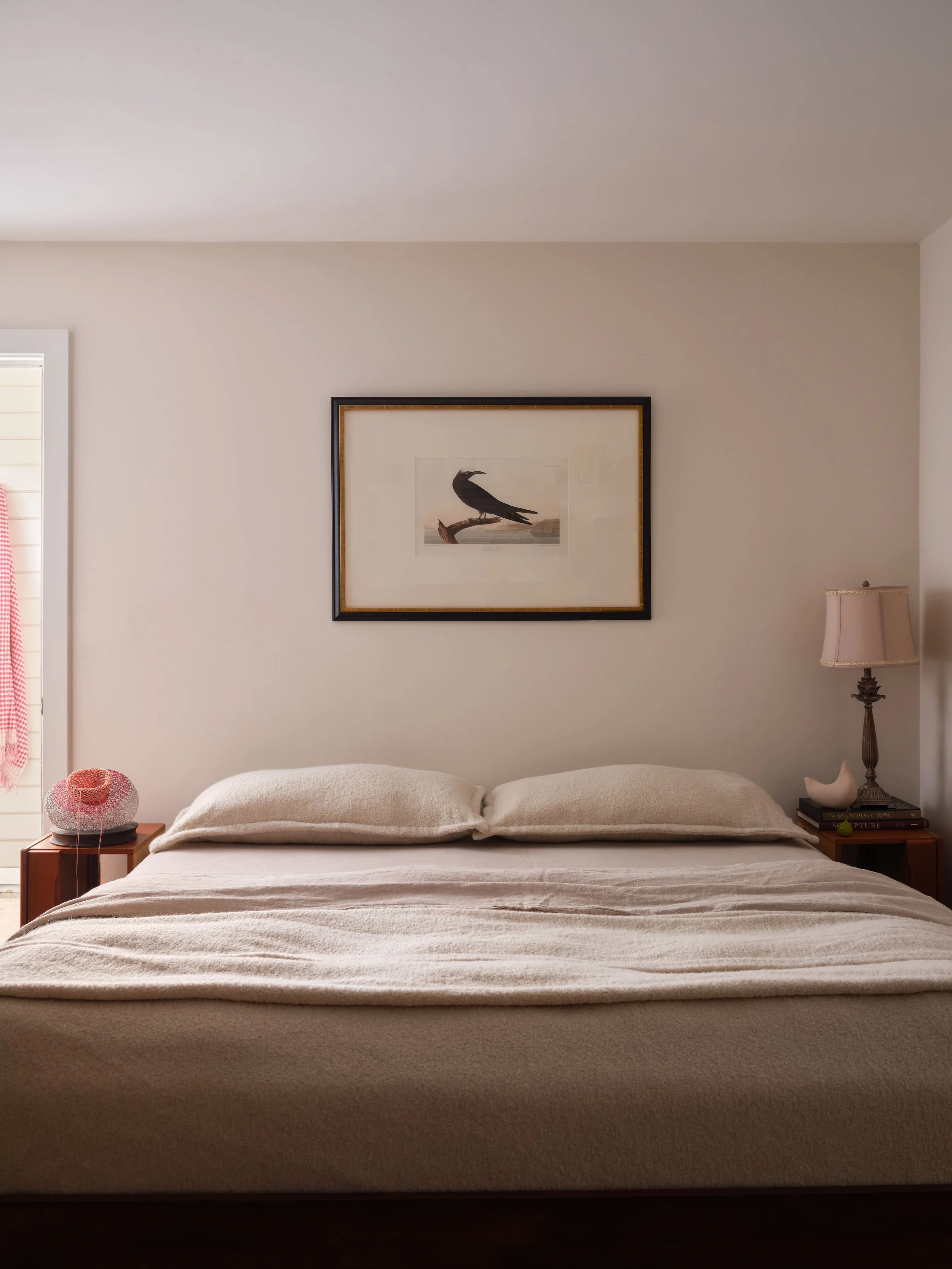 Bedroom with framed bird print above the bed, square flush-mount ceiling light, and wood nightstand with table lamp, Alamo Farmhouse (Jackson Way) complete remodel by Spearman Spaces