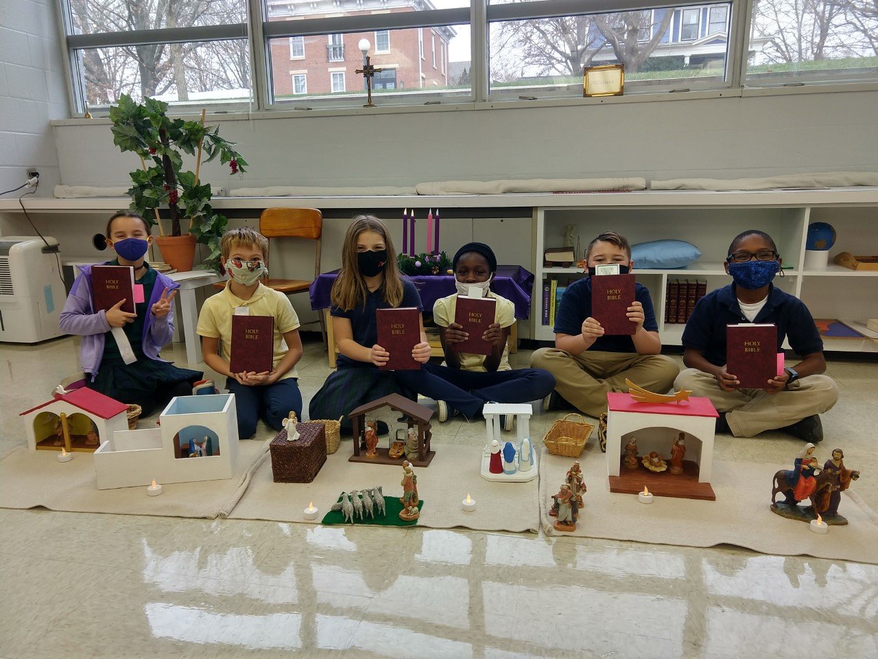 Holy Cross Students with Bibles and Nativities.jpg
