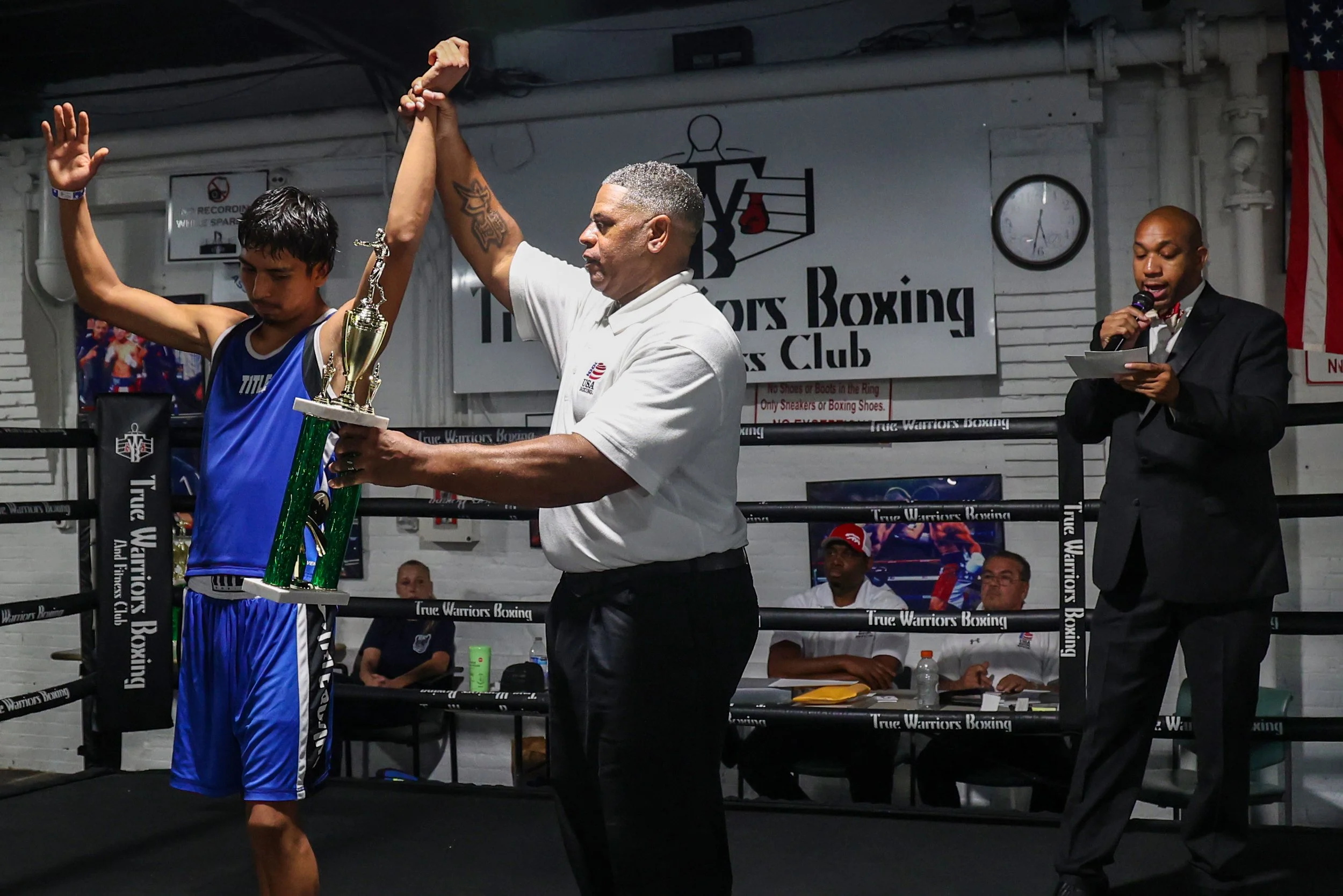 19-year-old boxer Erik Mendez raises his arm after his fight at the True Warrior gym. Initially, it was ruled that he lost the fight, but the decision was later reversed, when an error was discovered on the judge’s scorecard. 
