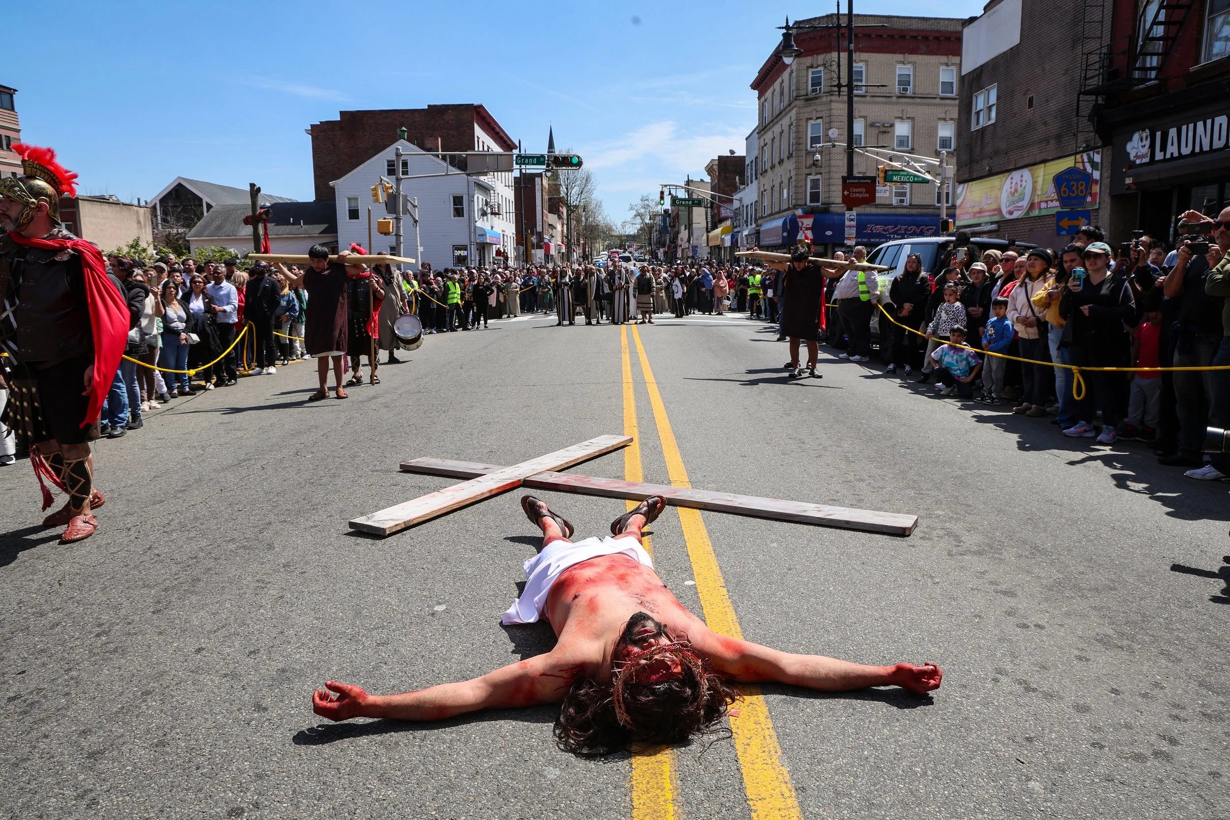 PATERSON, N.J. | April 18, 2025: Sebastian Delgado portrays Jesus during an emotional Good Friday Passion Play on the streets of Paterson. The annual Way of the Cross reenactment traces Jesus Christ’s final hours—from arrest to crucifixion—beginning 