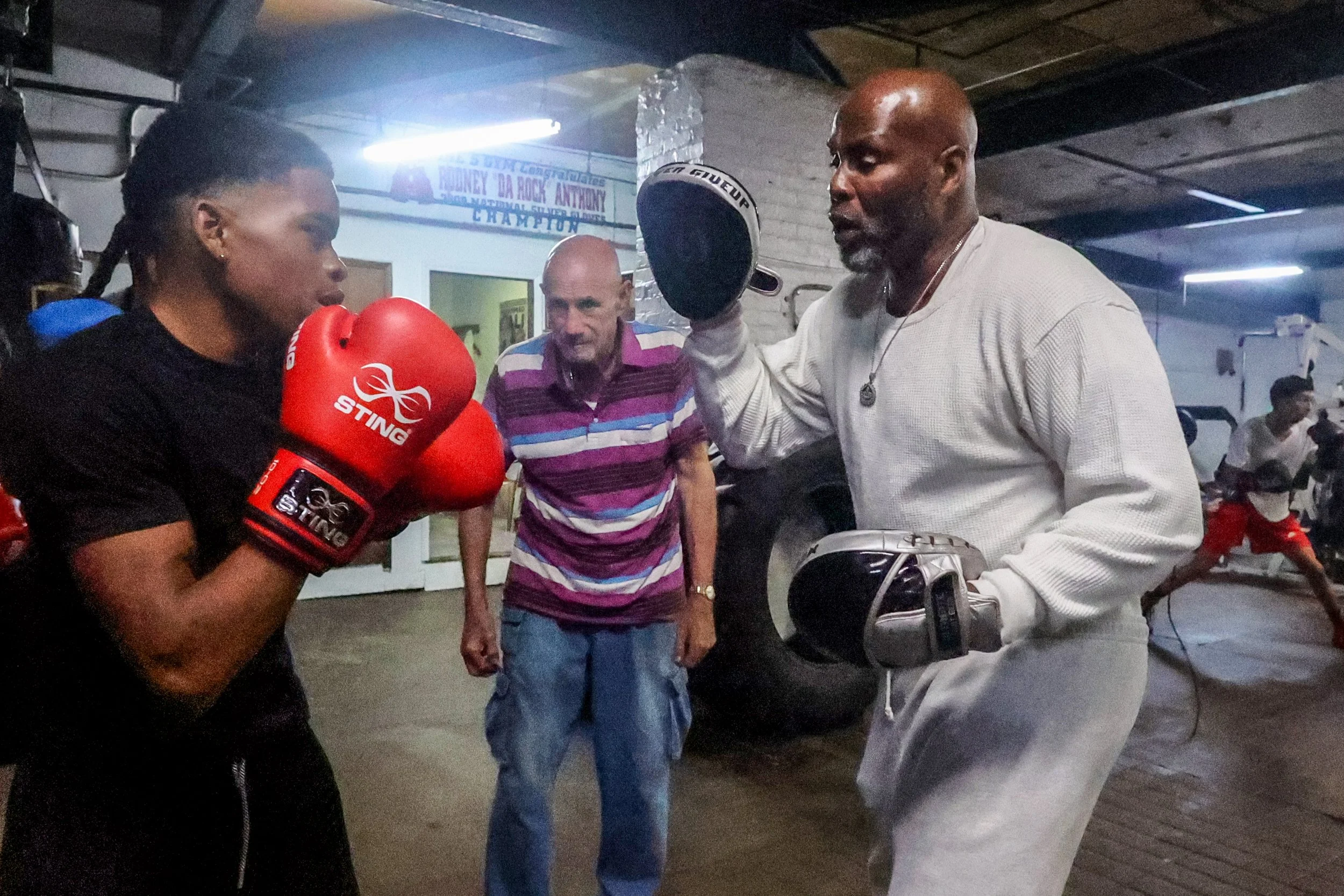 Trainer Ron Rasul Bacote works with 14-year-old Ashanti Bailey of Paterson under the watchful eye of Phil Shevack