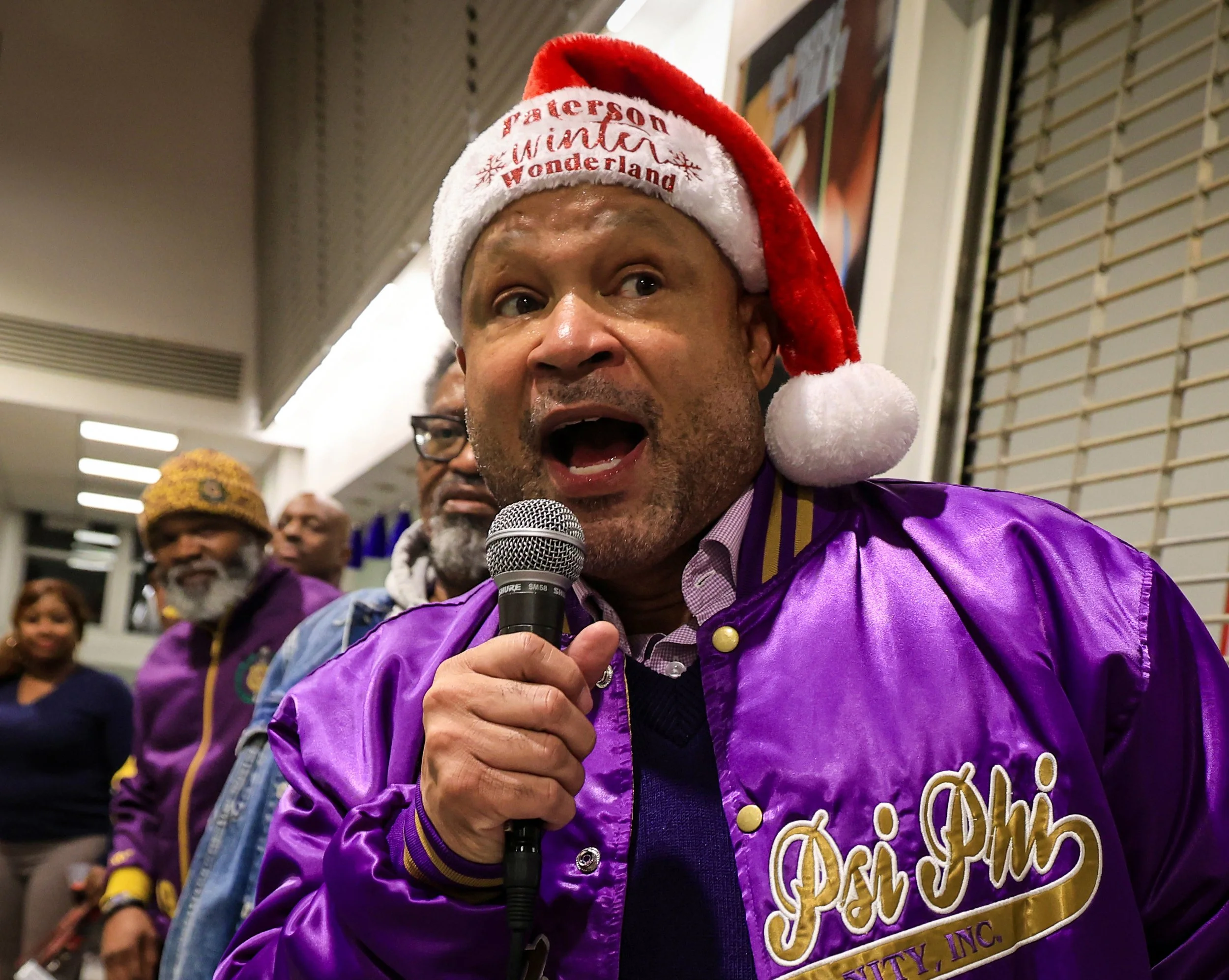 ATERSON, N.J. | 12/17/25: NJ State Senator Benjie Wimberly greets residents at the annual community holiday celebration at Eastside High School. The event featured an all-you-can-eat turkey and ham dinner with sweet potato pie and cornbread, free hai