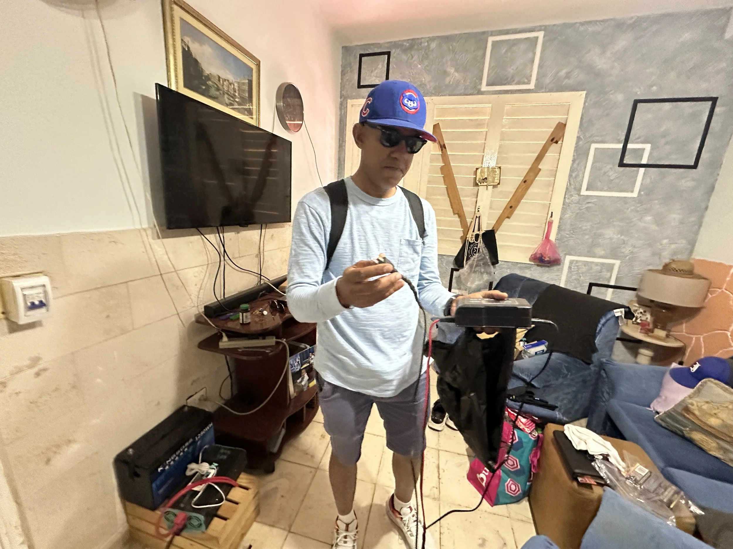 HAVANA, CUBA — March 8, 2026: Luis Campos, a tour guide in Central Havana (Centro Habana), displays a broken power inverter he uses during frequent blackouts. A tour guide by trade, he says business is down nearly 90 percent amid declining tourism fo