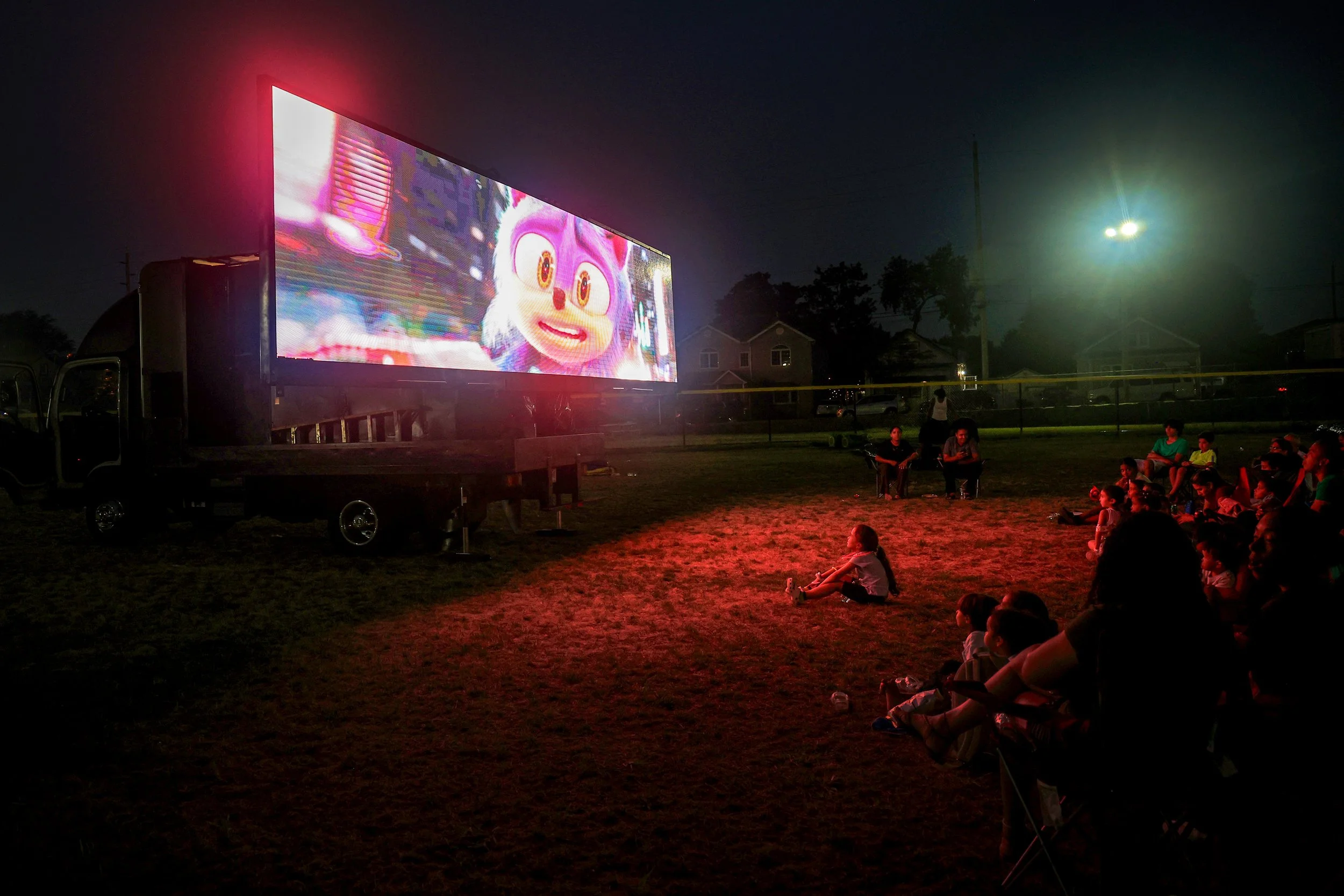 PATERSON, N.J. | Aug. 5, 2025: After the sun set, families gathered on the grass at School 25 in Paterson’s 6th Ward for an outdoor screening of Sonic 3 during National Night Out. Celebrations took place across all six wards, with block parties, cook