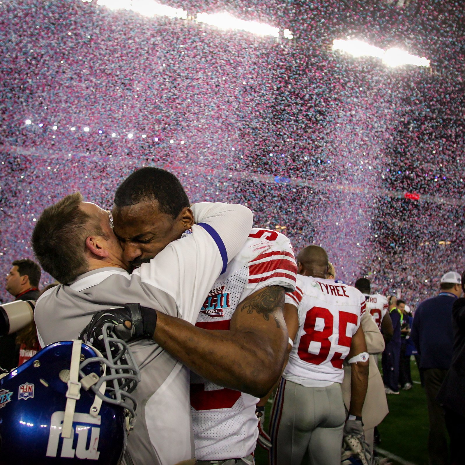 Giants defensive coordinator, Steve Spagnola hugs one of his players.