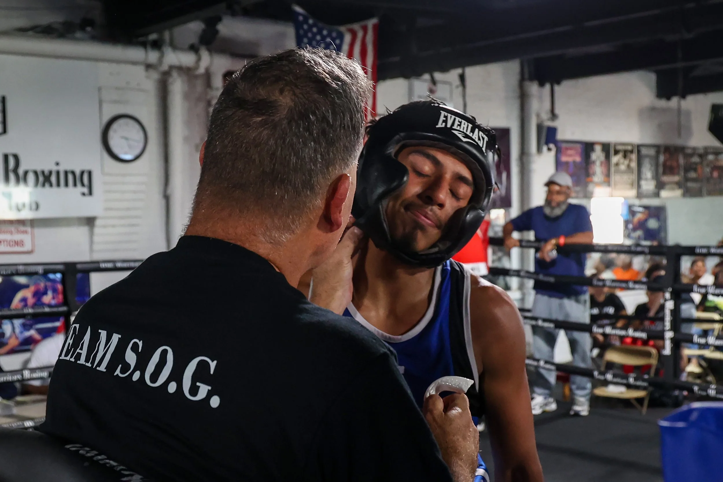 Young boxer Erik Mendez show his disappointment in his performance with trainer Ken DeBerry after his fight at True Warriors gym.