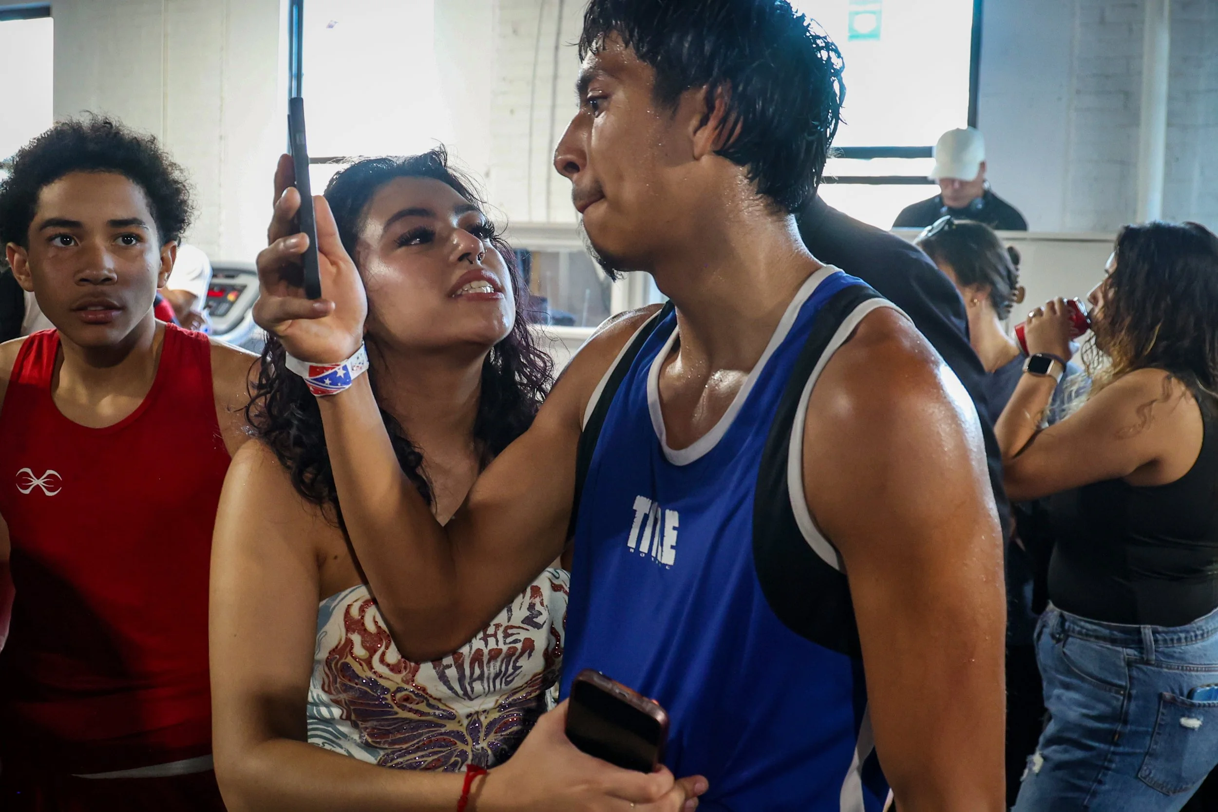 19-year-old boxer Erik Mendez re-watches his fight recorded on a smartphone by his fiancé Joselyn Cano after his fight at the True Warrior gym. The decision was later reversed, when an error was discovered on the judge’s scorecard. He was later ruled