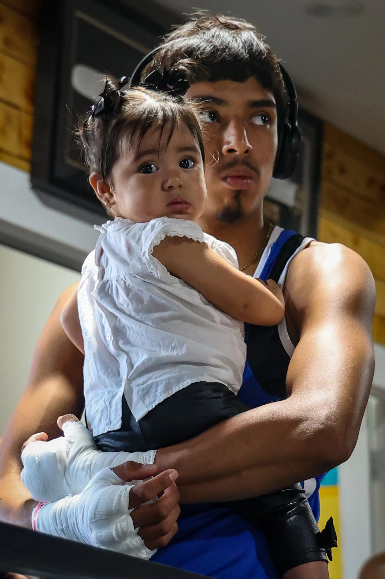 Boxer Erik Mendez hold his daughter Isabella while waiting for his fight at the True Warriors Boxing gym in Paterson. 