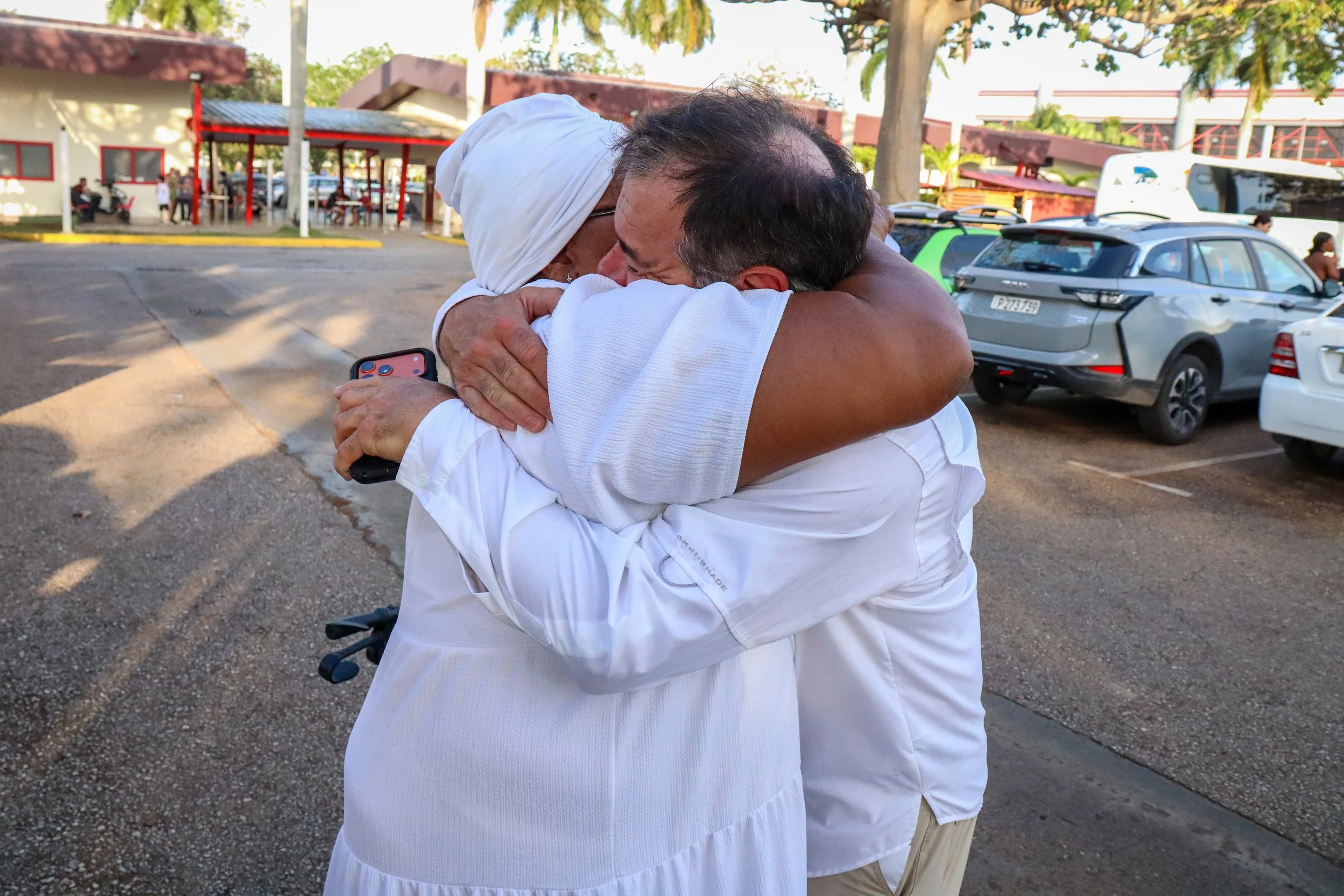 HAVANA, CUBA — March 7, 2026: Chuck Fazio, a retired businessman from Washington, D.C., hugs Iliana Macias Pulido, known as “Mama,” after delivering four bags—nearly 400 pounds—of food and cooking supplies to support her small community kitchen in La