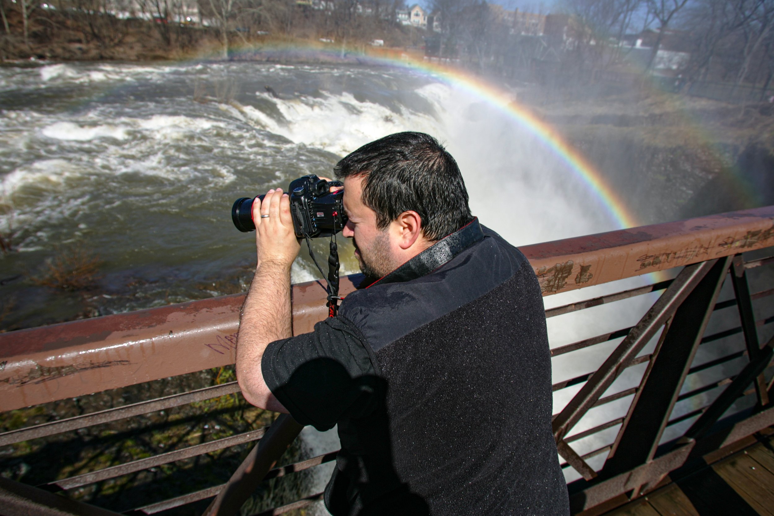 03-16-10 PATERSON: photographer, Anthony Quintano photographs the high water coming over the falls which formed a spectacular rainbow.