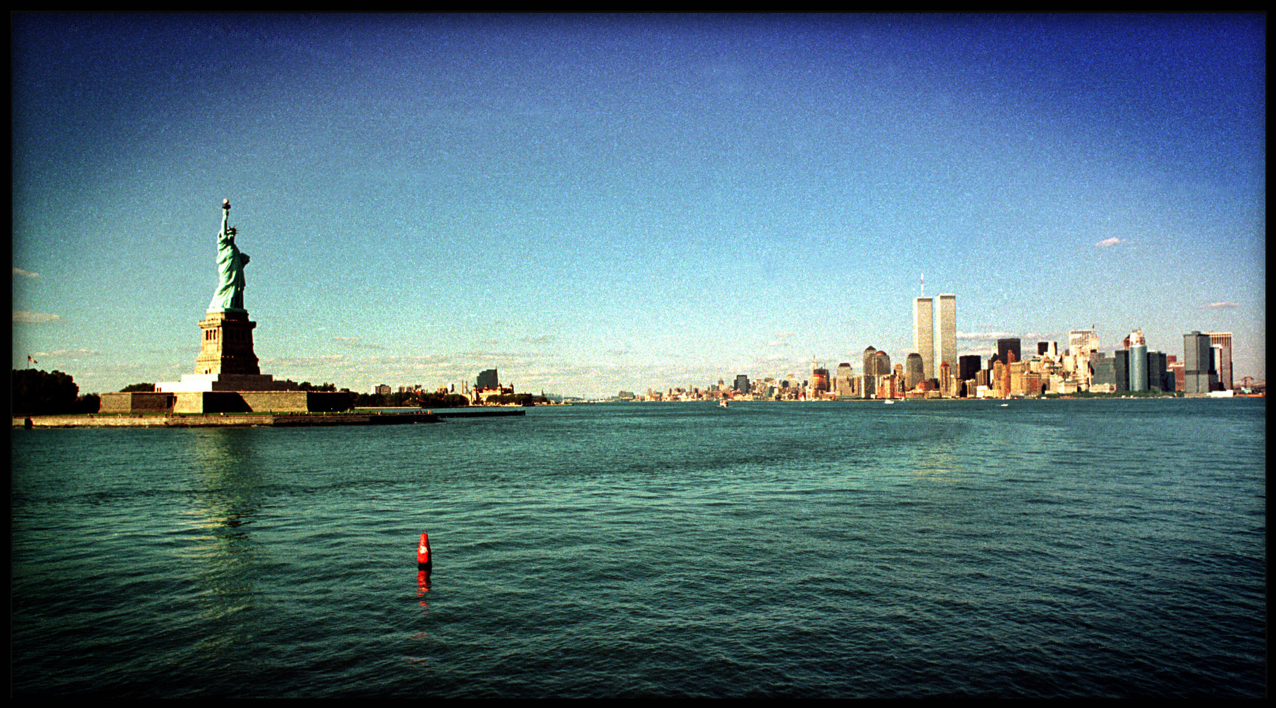Circa 1992: The Statue of Liberty and the World Trade Center towers, Photo taken from across the Hudson river in Jersey City at Liberty State Park