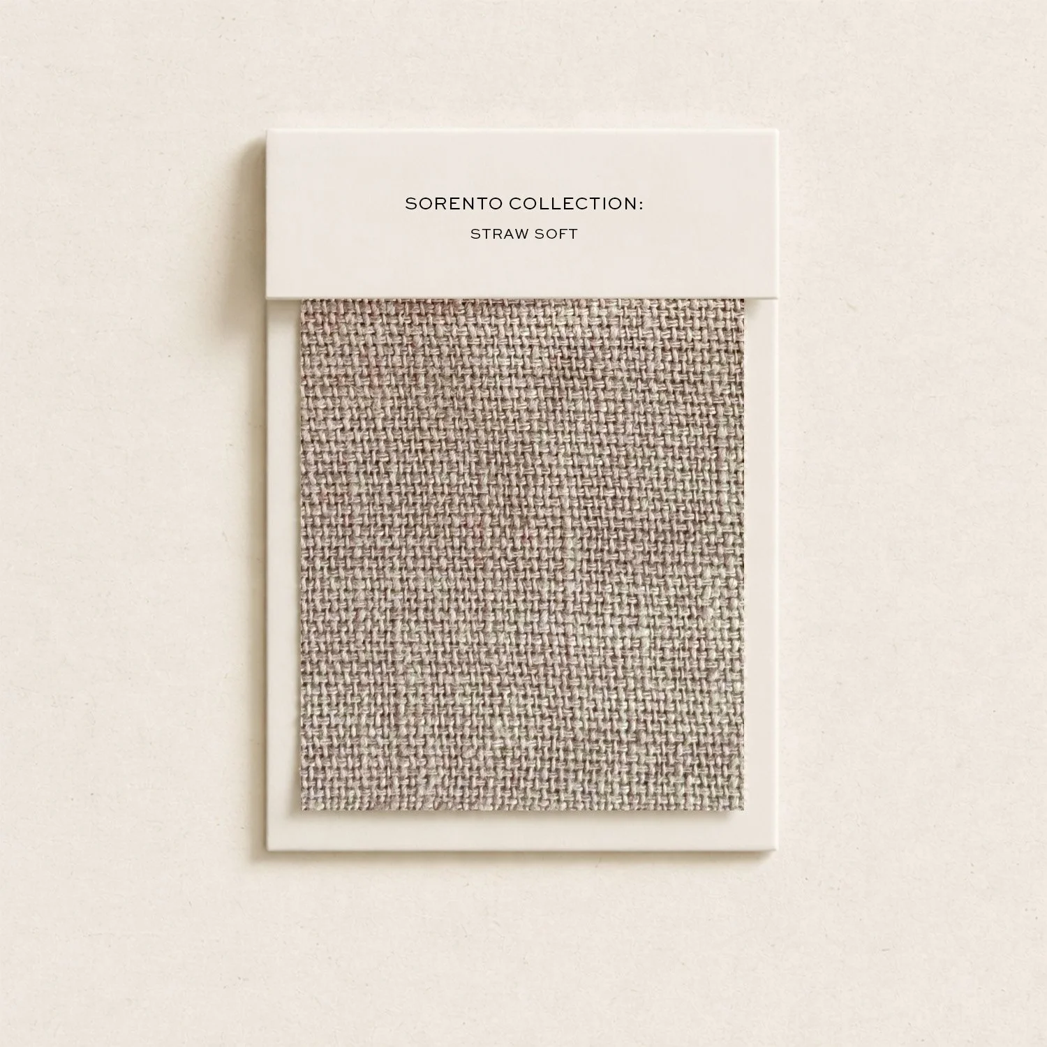 Swatch of beige straw soft fabric on display with a white label that reads 'Sorento Collection: Straw Soft'.