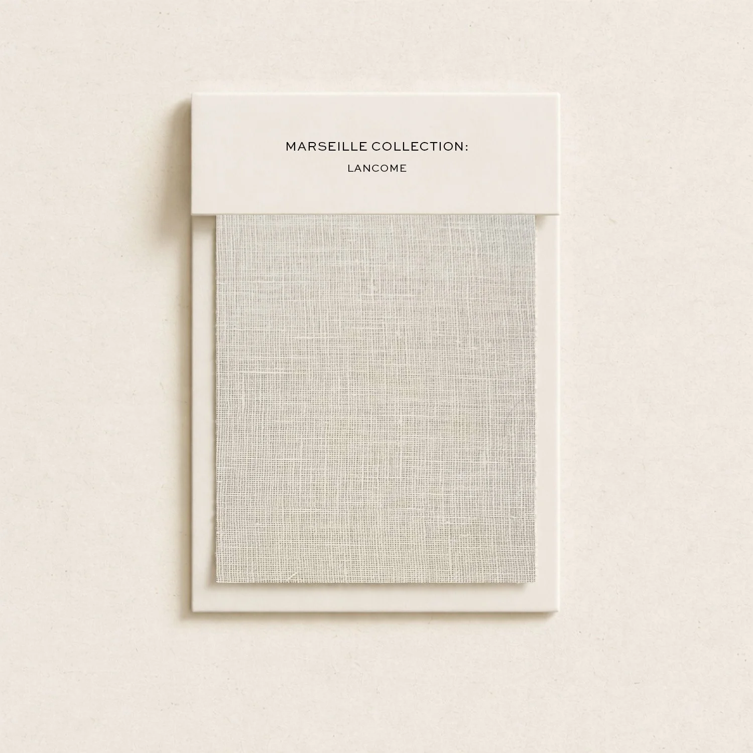 Packaging for Marseille Collection by Lancôme featuring a white box and textured fabric sample.