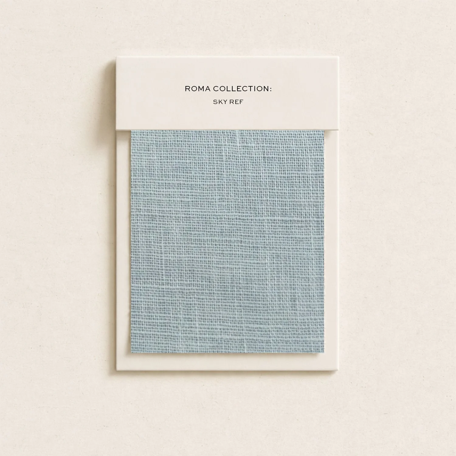 A light blue fabric sample with a fine woven pattern displayed on a white background, labeled 'ROMA COLLECTION: SKY REF'.