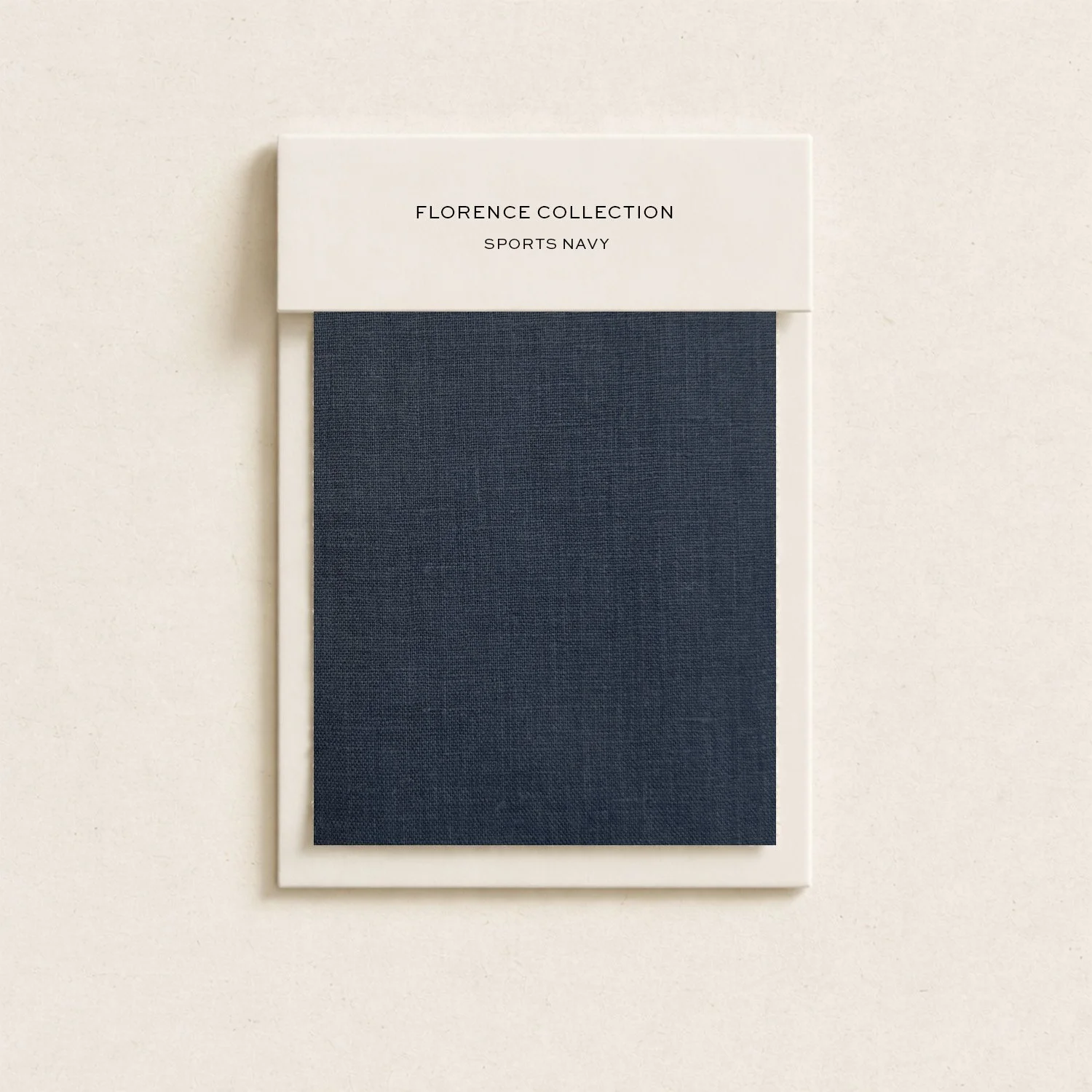 Sample fabric swatch in navy color on white card labeled "Florence Collection Sports Navy"