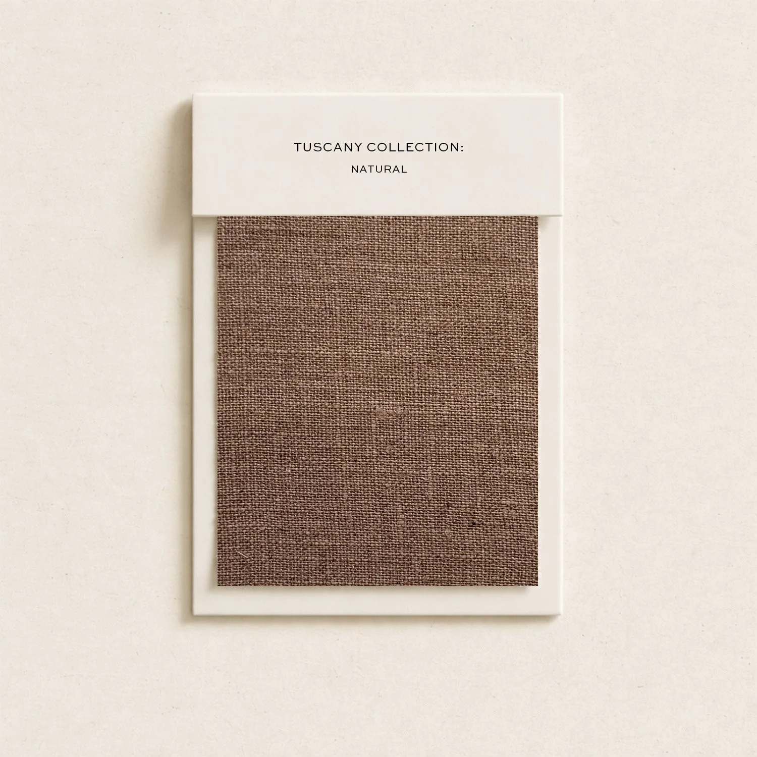 Color swatch sample card displaying a brown textile from the Tuscany Collection: Natural with a white border and text.