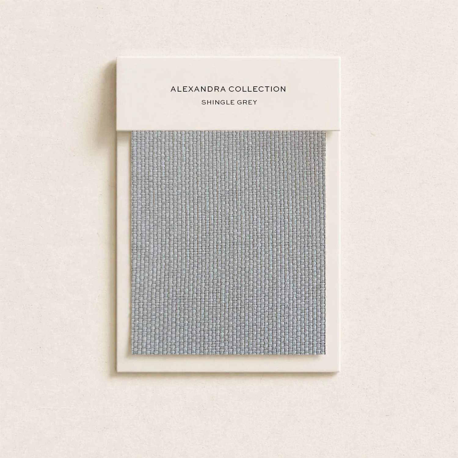 Sample swatch of light grey textured upholstery fabric from Alexandra Collection.