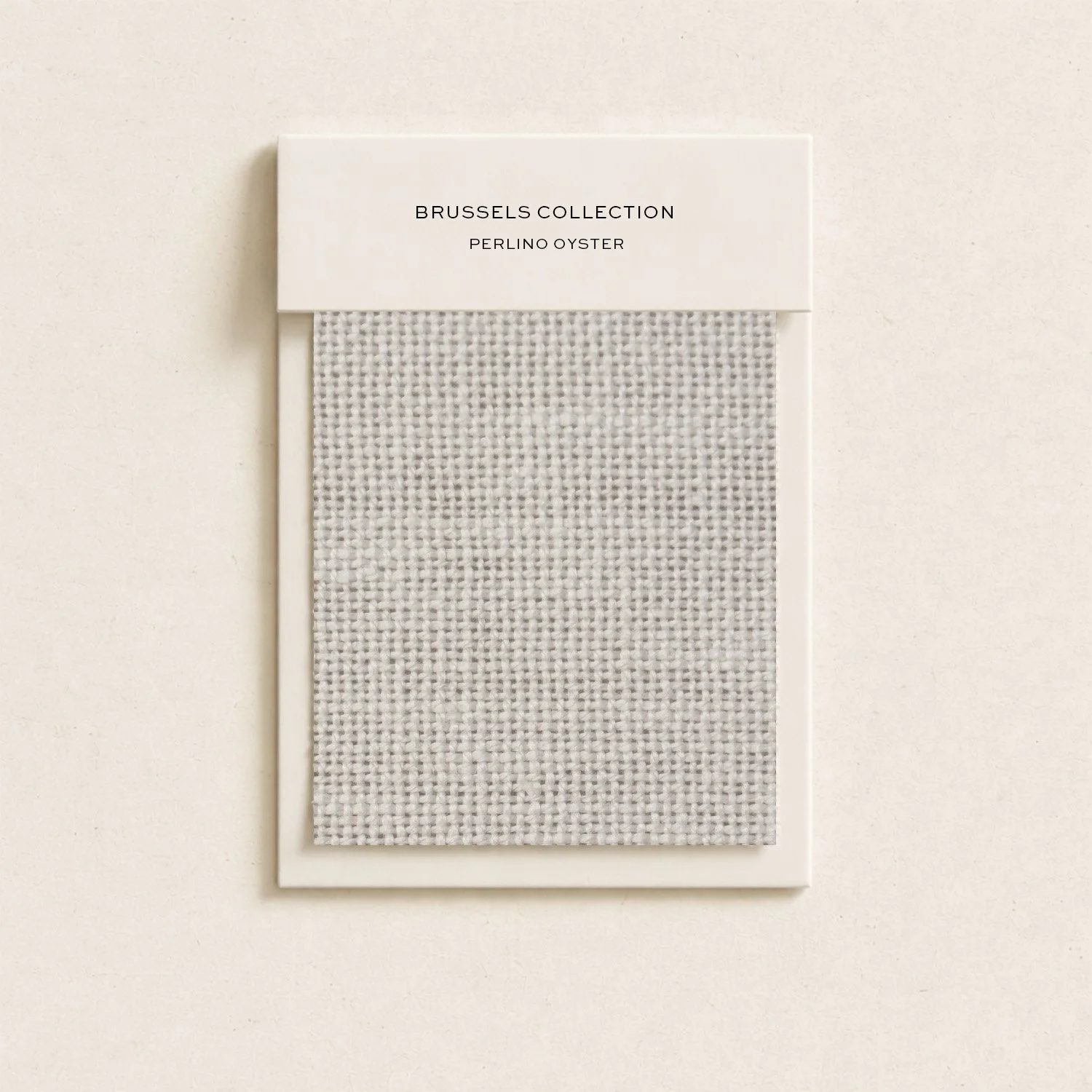 Sample swatch card for Brussels Collection Perlin Oyster tile showing a small fabric square in gray and white tones.
