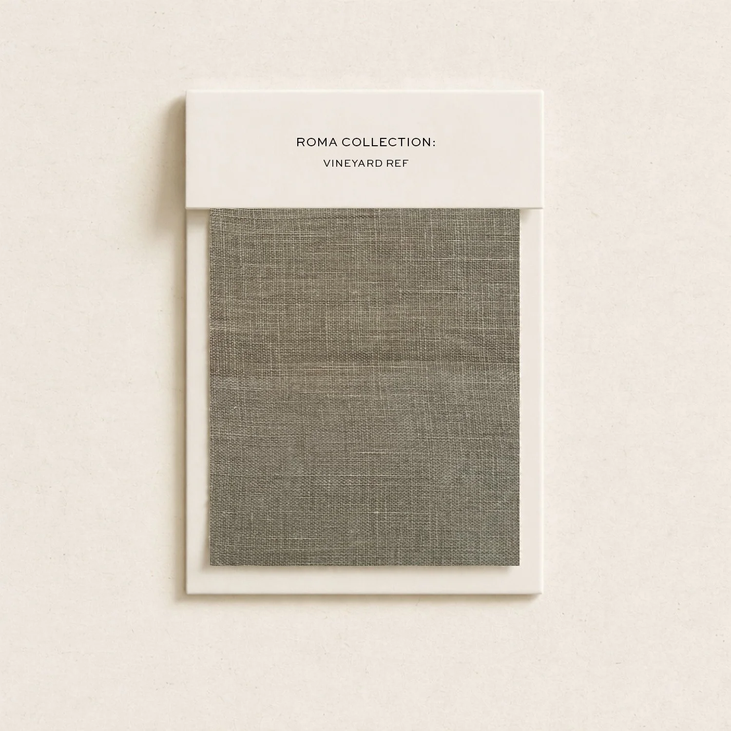 A fabric swatch sample from the Roma Collection, Vineyard Ref, in a neutral beige color, mounted on a white frame.