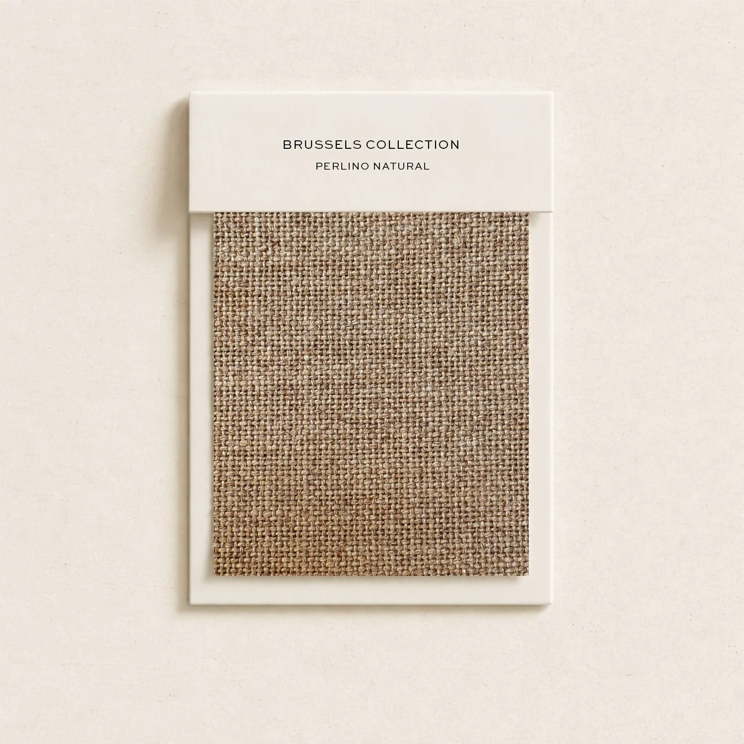 Color swatch of beige woven fabric labeled 'Brussels Collection, Perlino Natural' against a light-colored background.