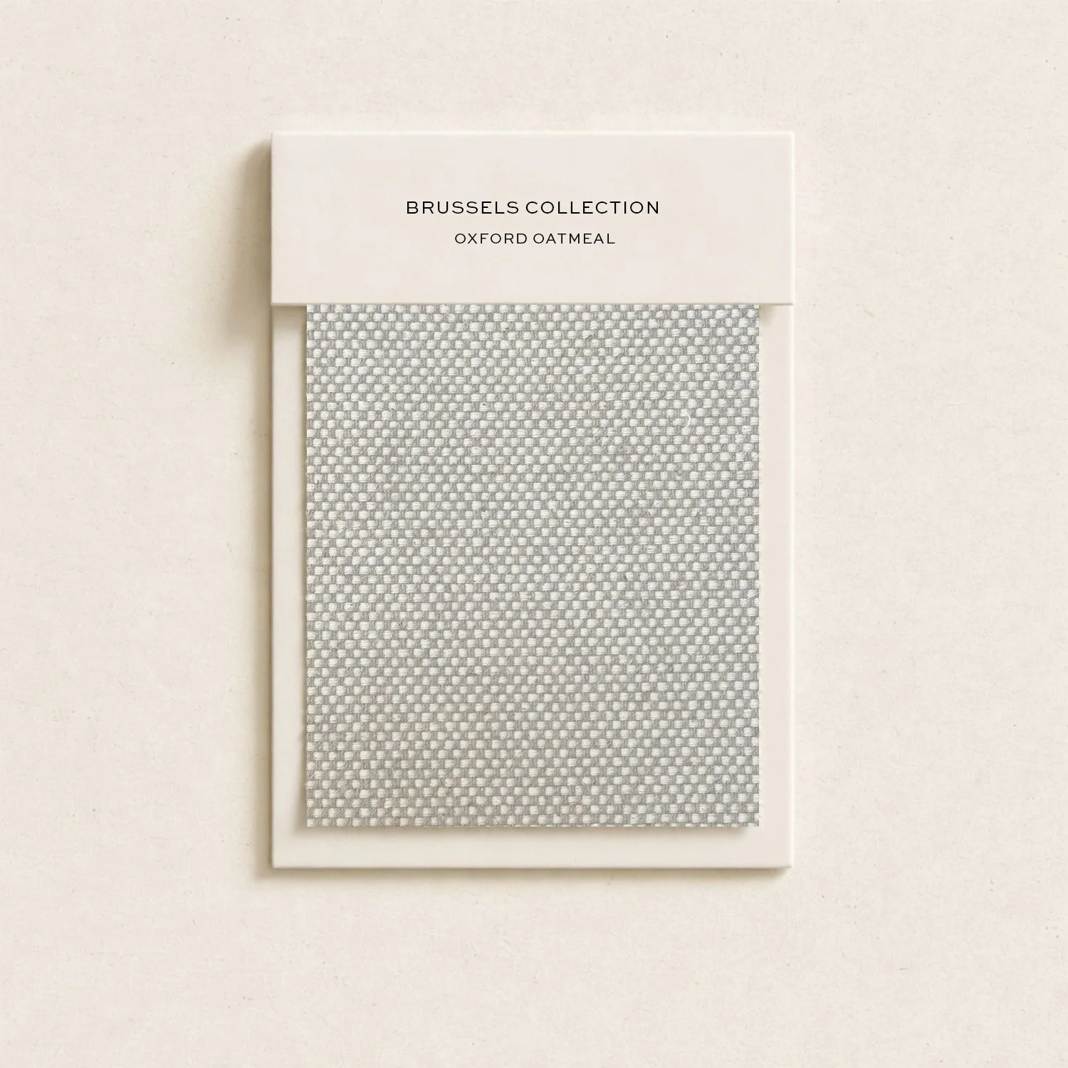 Sample fabric swatch labeled 'Brussels Collection, Oxford Oatmeal' installed on a card.