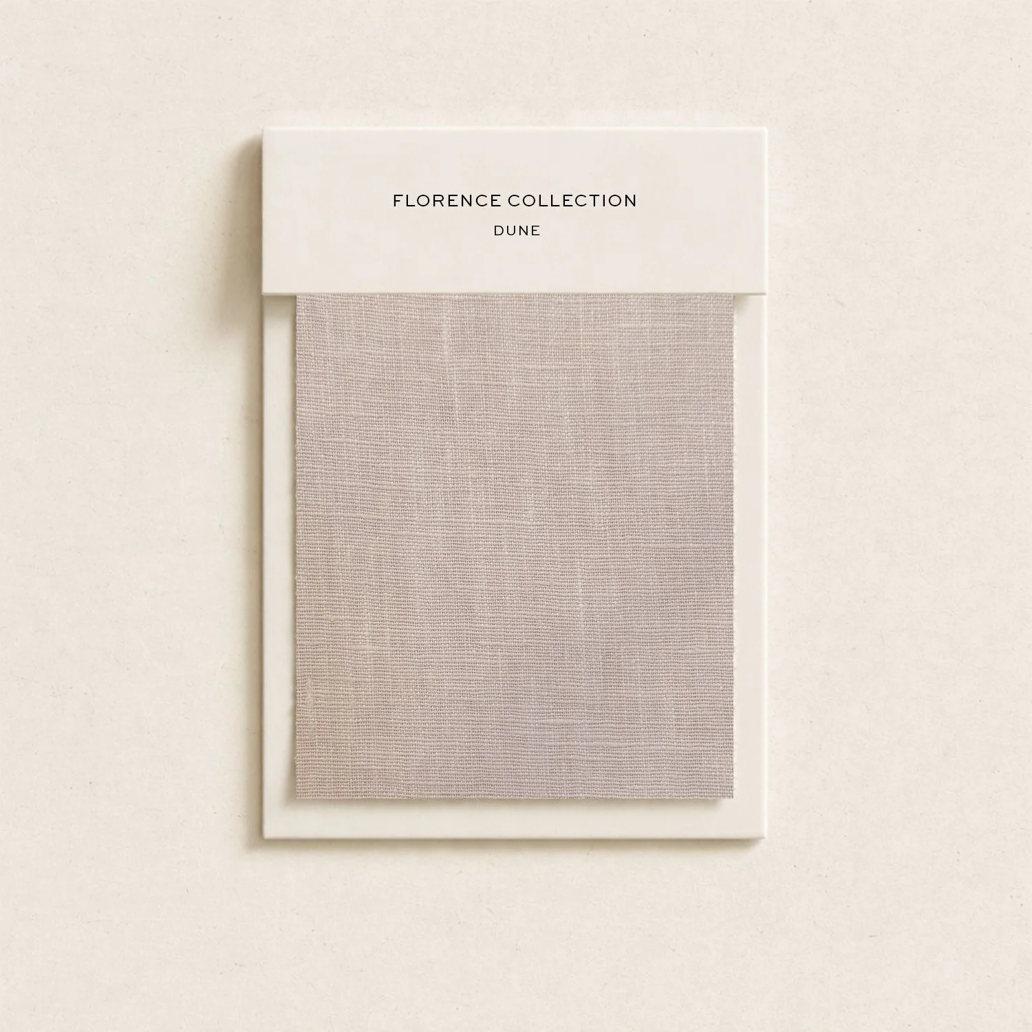Color swatch sample card labeled 'Florence Collection Dune' with fabric in light beige color.