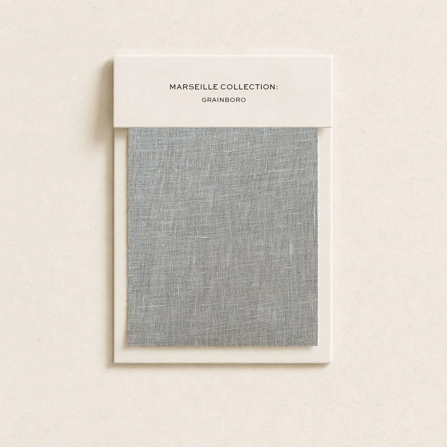 A fabric sample card from the Marseille Collection by Grainboro, displaying a grey woven fabric swatch.