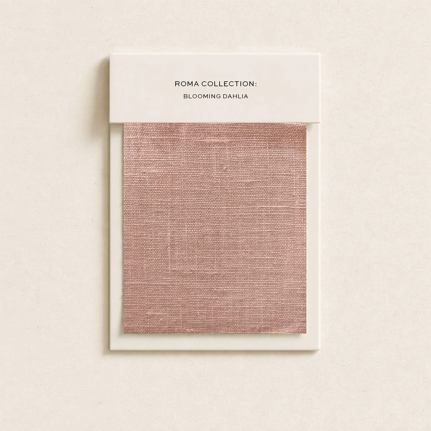 A fabric sample card labeled 'Roma Collection: Blooming Dahlia' featuring a pink, textured fabric swatch.