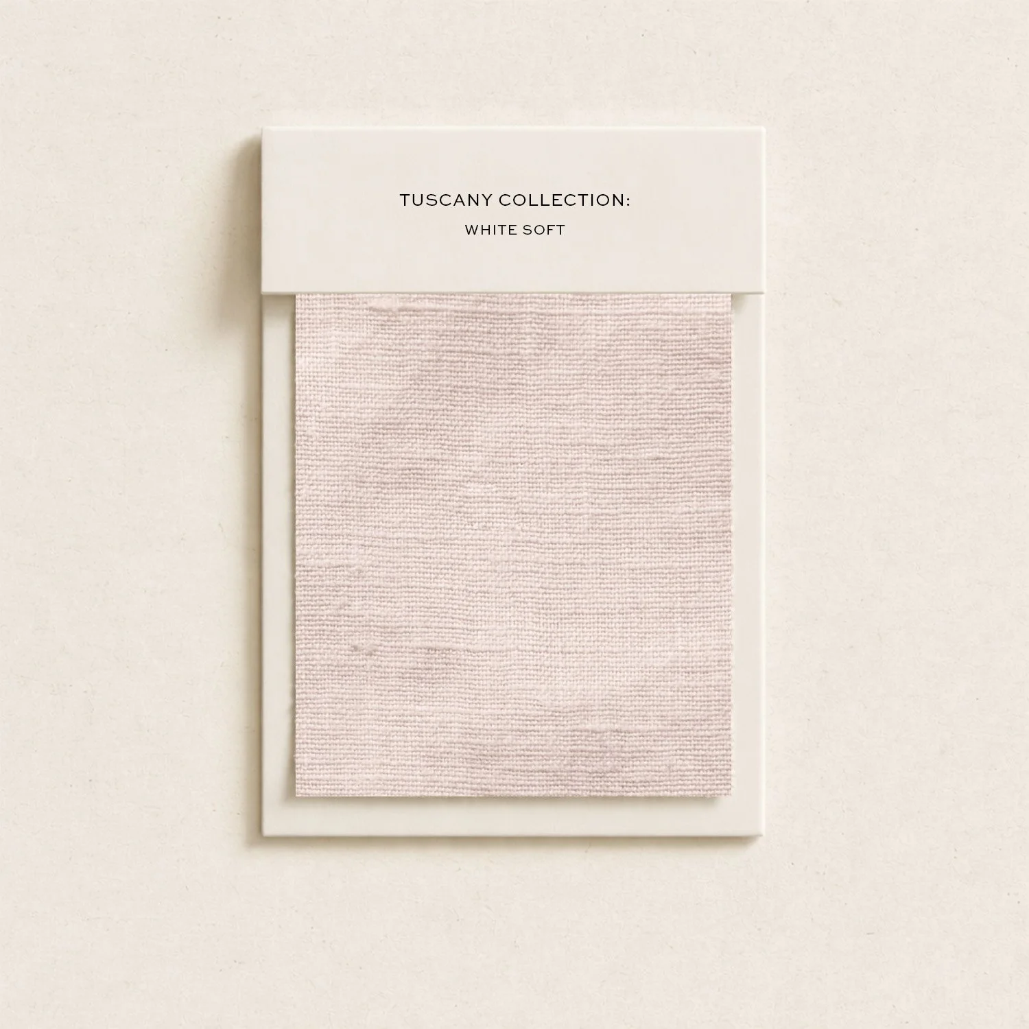 Paint swatch sample card in white and light pink shades against a plain background.