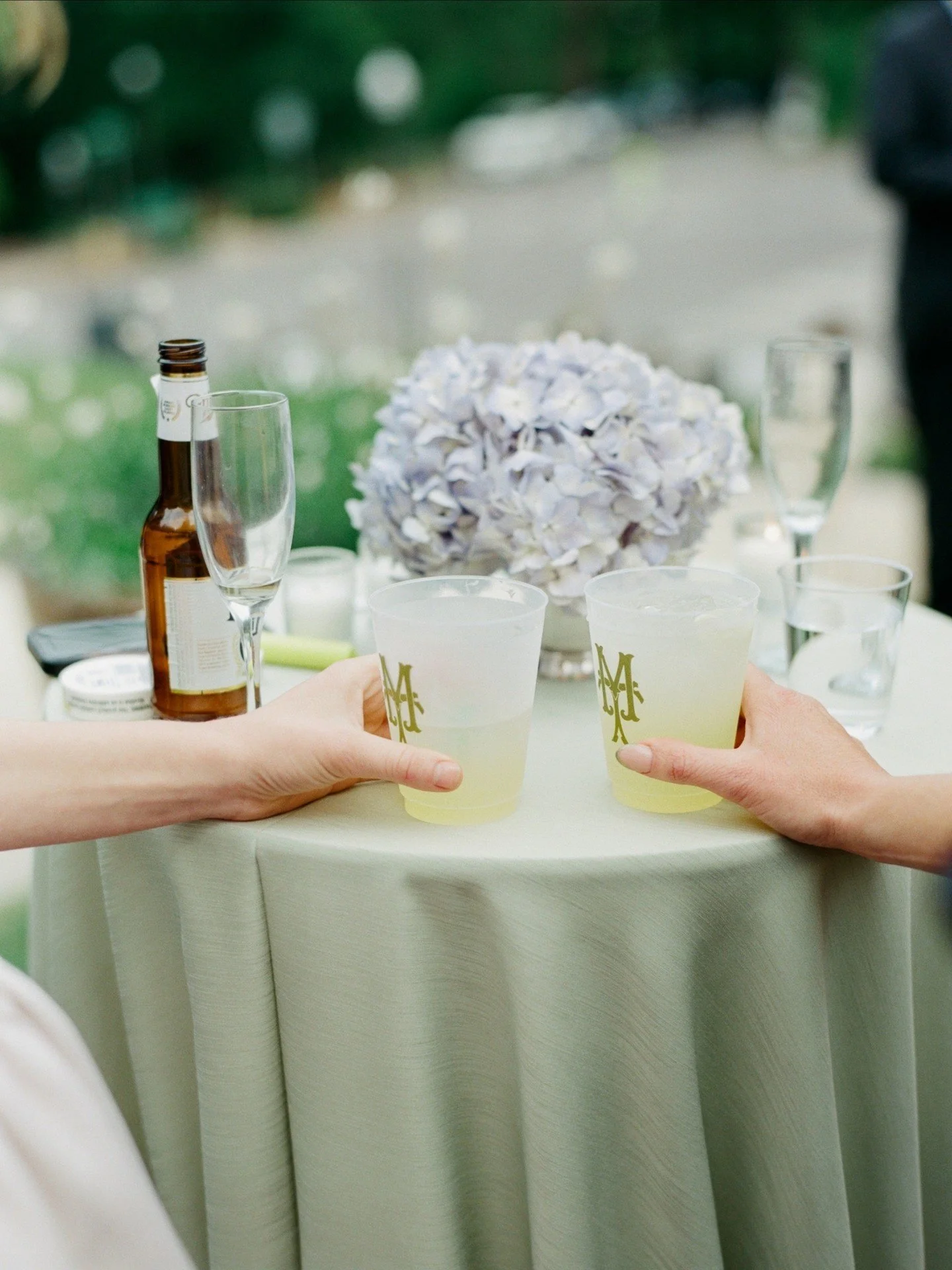 Madeline and Tim&rsquo;s reception was the perfect blend of elegance and personality. The soft green and blue color palette created such a refined outdoor setting in the courtyard. From the sleek acrylic signage to the custom dog napkins, every detai