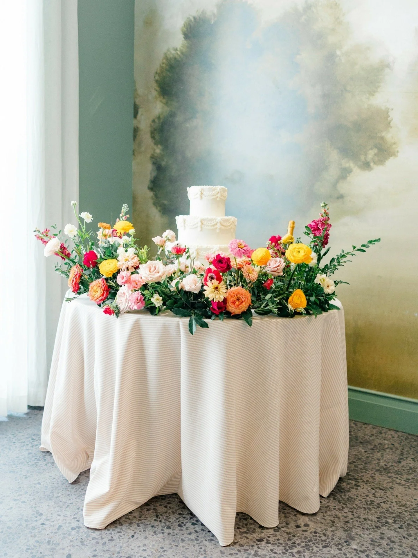 One of my favorite moments from Ohtra + Michael&rsquo;s night was their cake cutting! The cake itself was a showstopper &mdash; delicate piping, vibrant florals, and so perfectly them. As they stood side by side, laughing and feeding each other that 