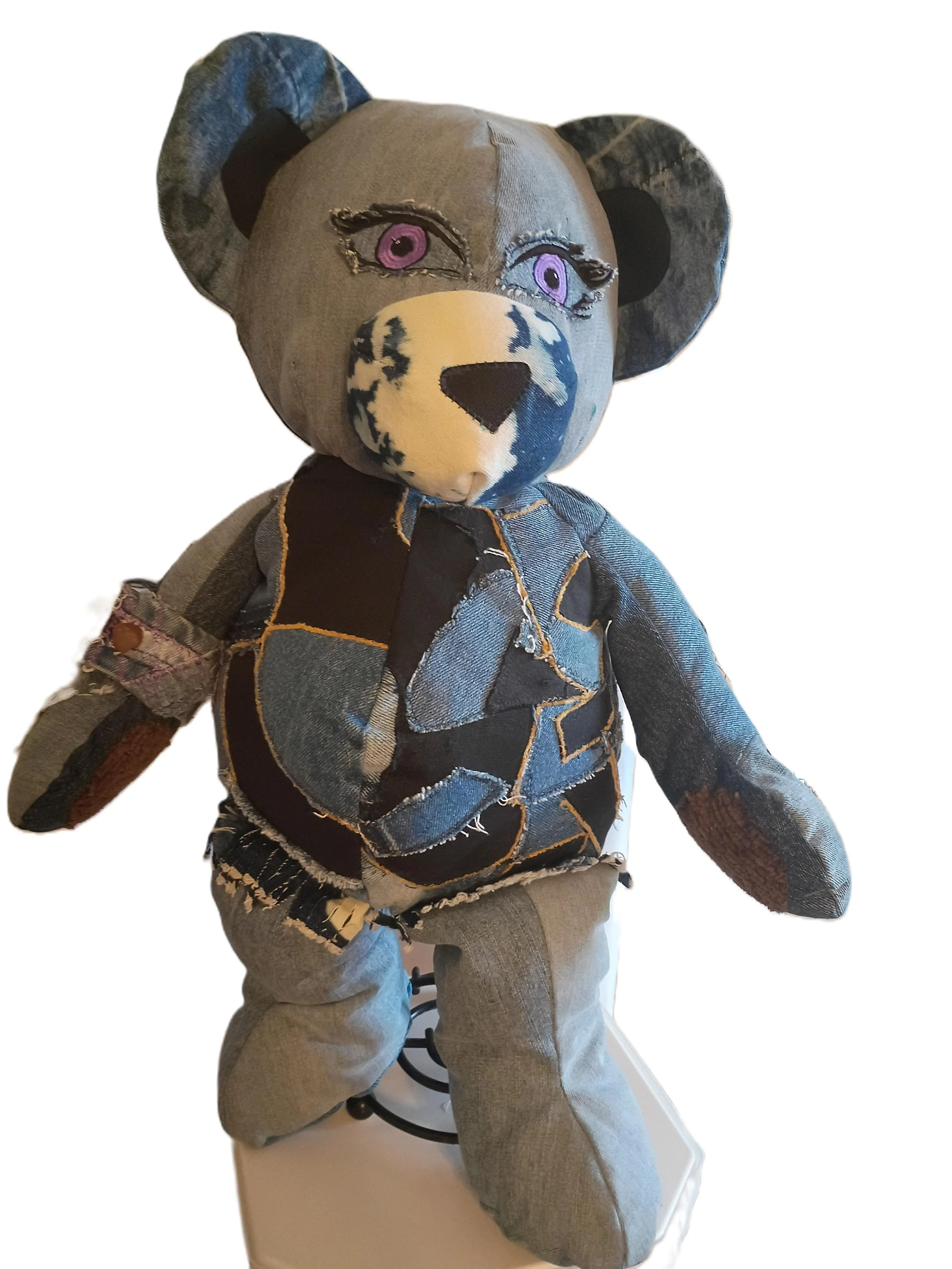 Aurelia, Figure of Healing & Transformation (WTS-2025-06/10)Aurelia was a sight to behold, her body a mosaic of black and blue patches, each one carefully stitched together with shimmering gold thread. Her eyes, deep and reflective, were a blend of w