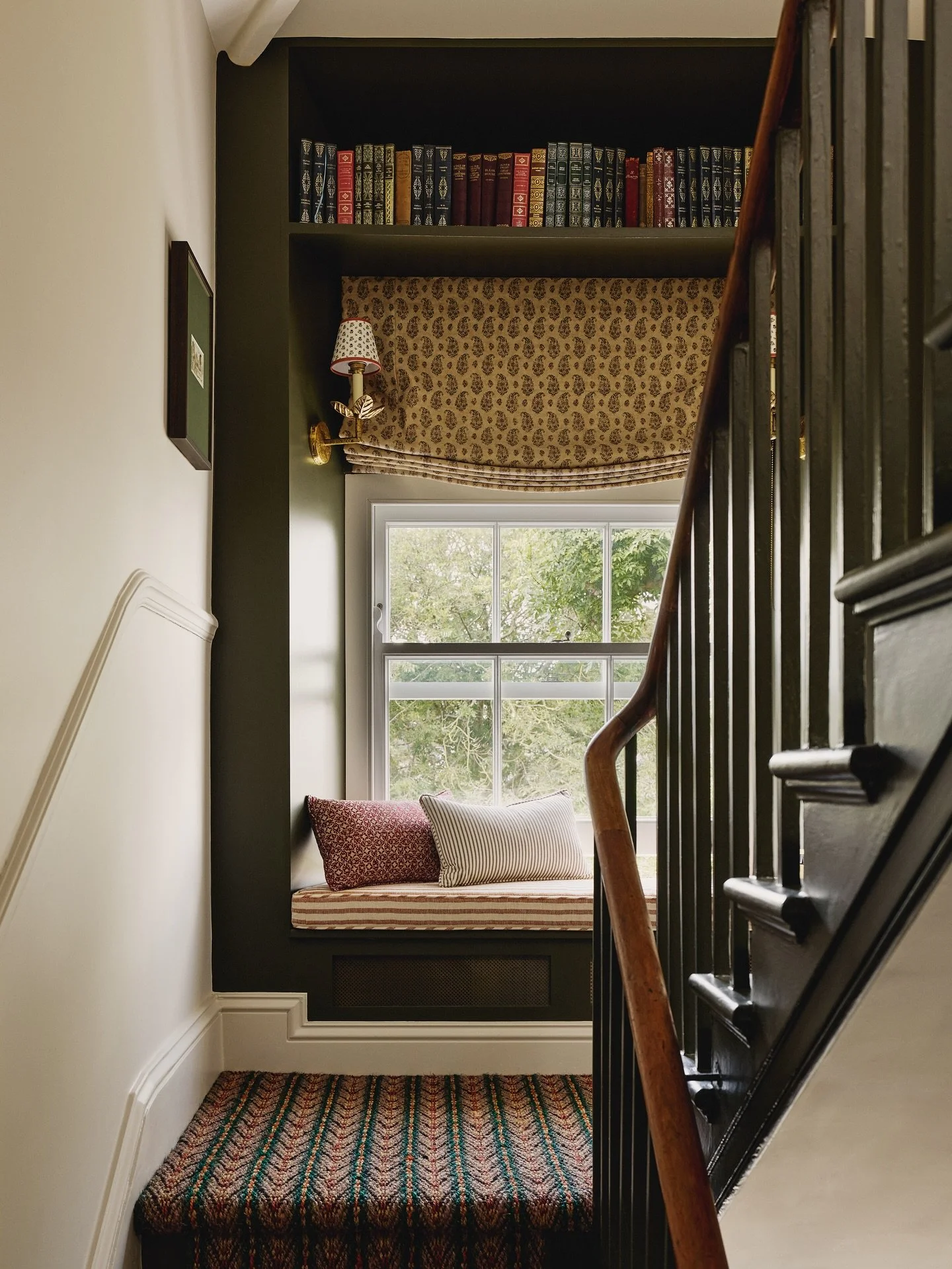 A favourite shot of a little reading nook we created on a half landing of this handsome original staircase in my Clapham townhouse project. Using rich jewel tones with the paintwork in Invisible Green by @littlegreenepaintcompany, it&rsquo;s now a co