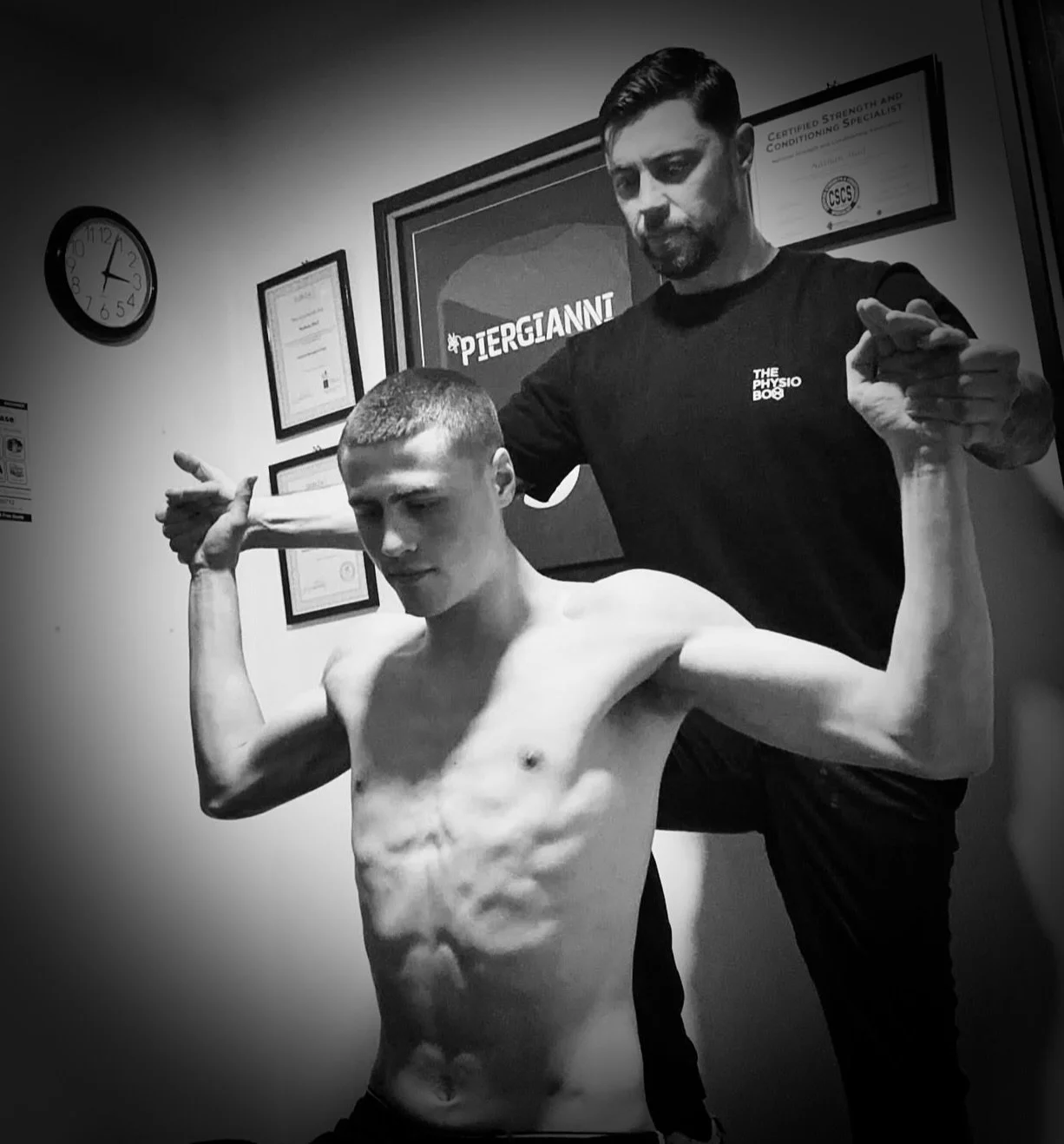 Young boxer being treated for a shoulder injury by Nathan Hall Specialist Physiotherapist in Altrinchm