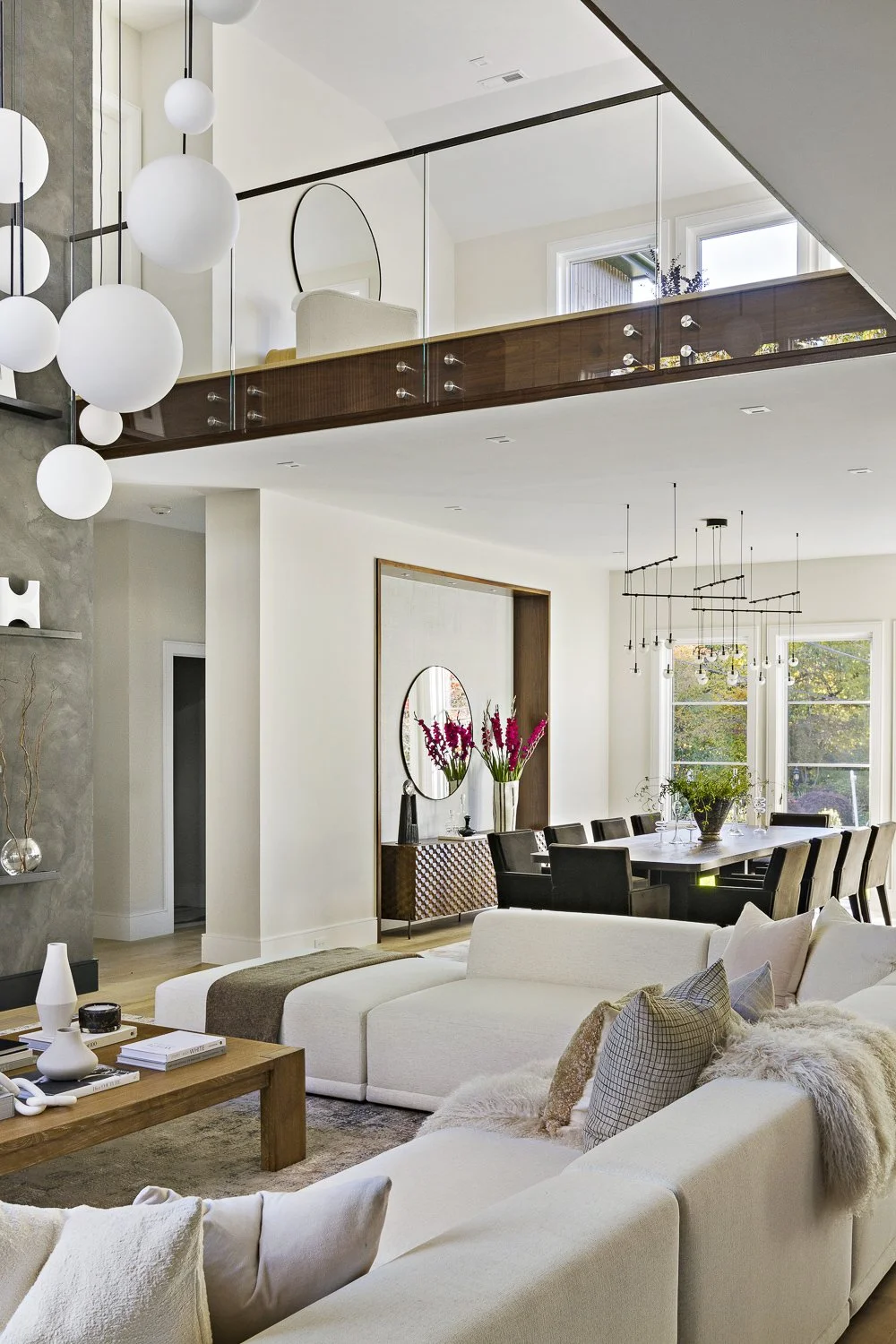 The living room with the textured accent wall + hanging globe lights