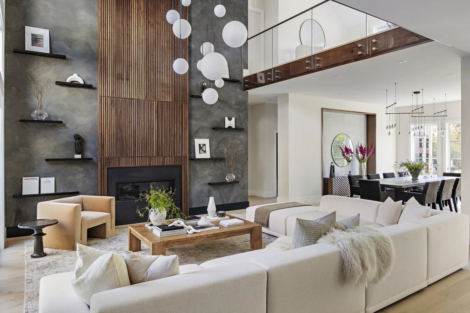The living room with the textured accent wall + hanging globe lights