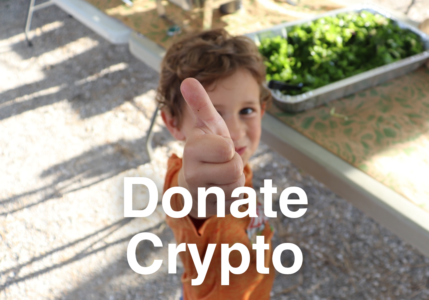 Text reads "Donate Crypto" with clickable image featuring an adorable child with great parents giving a thumbs up eating fresh local food at CCUA's Volunteer Appreciation Dinner. Link takes the reader to more information on the topic of donating cryp