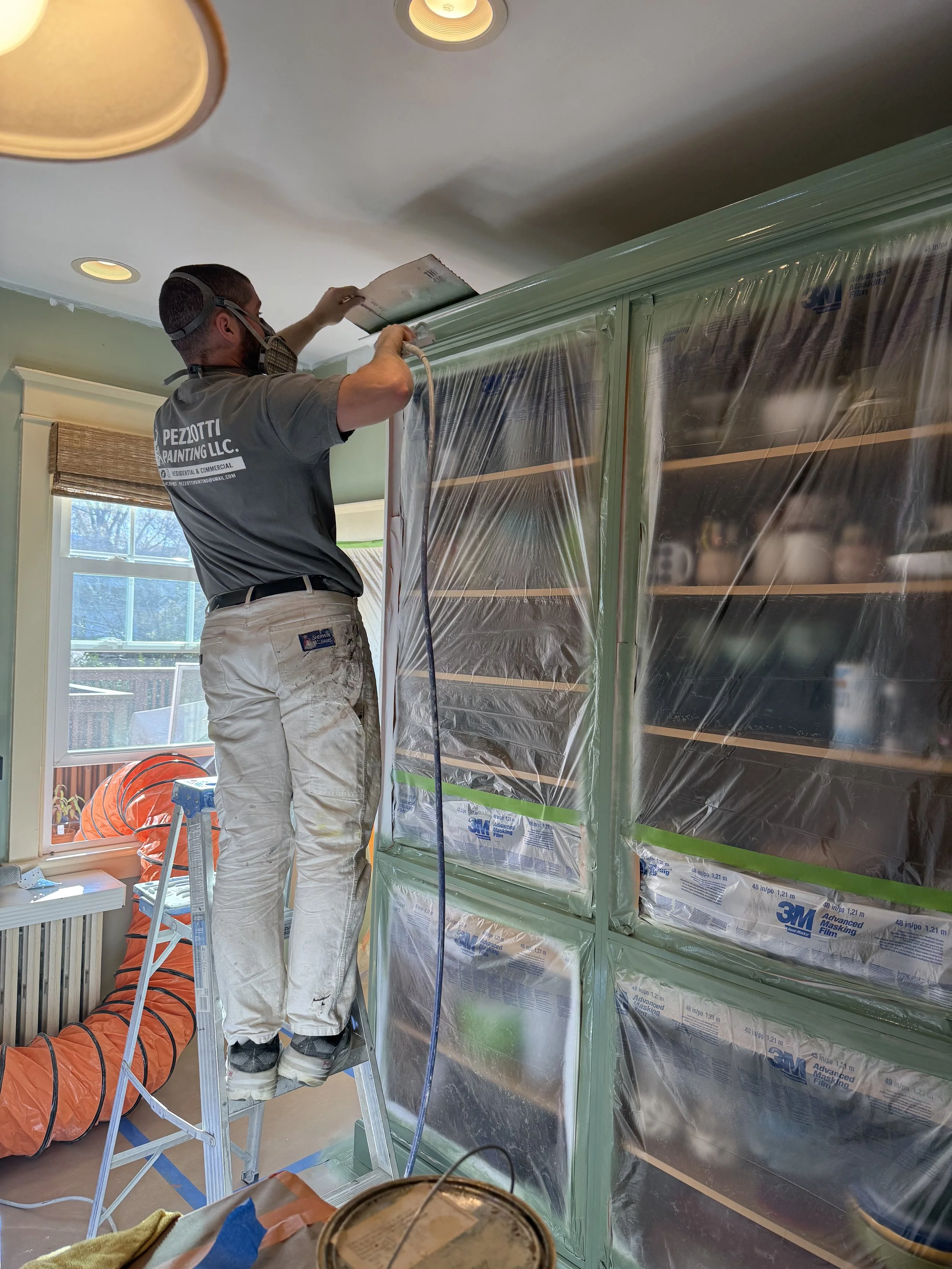 Spraying Thai Basil on a kitchen cabinet project in Haddonfield New Jersey 