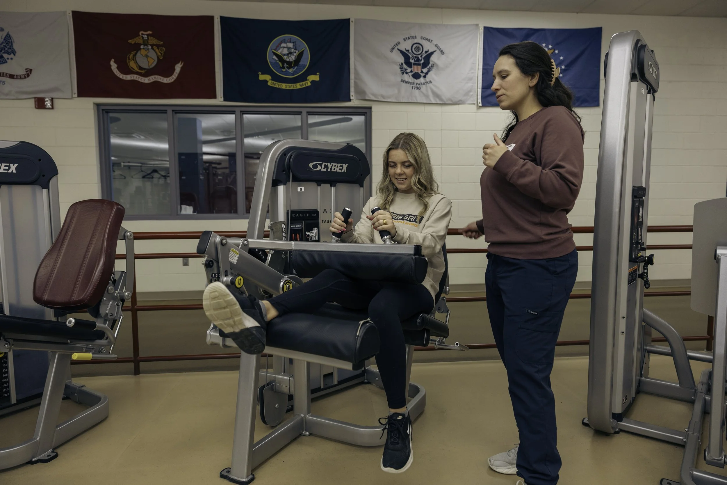 a patient working out on fitness equipment with a therapist